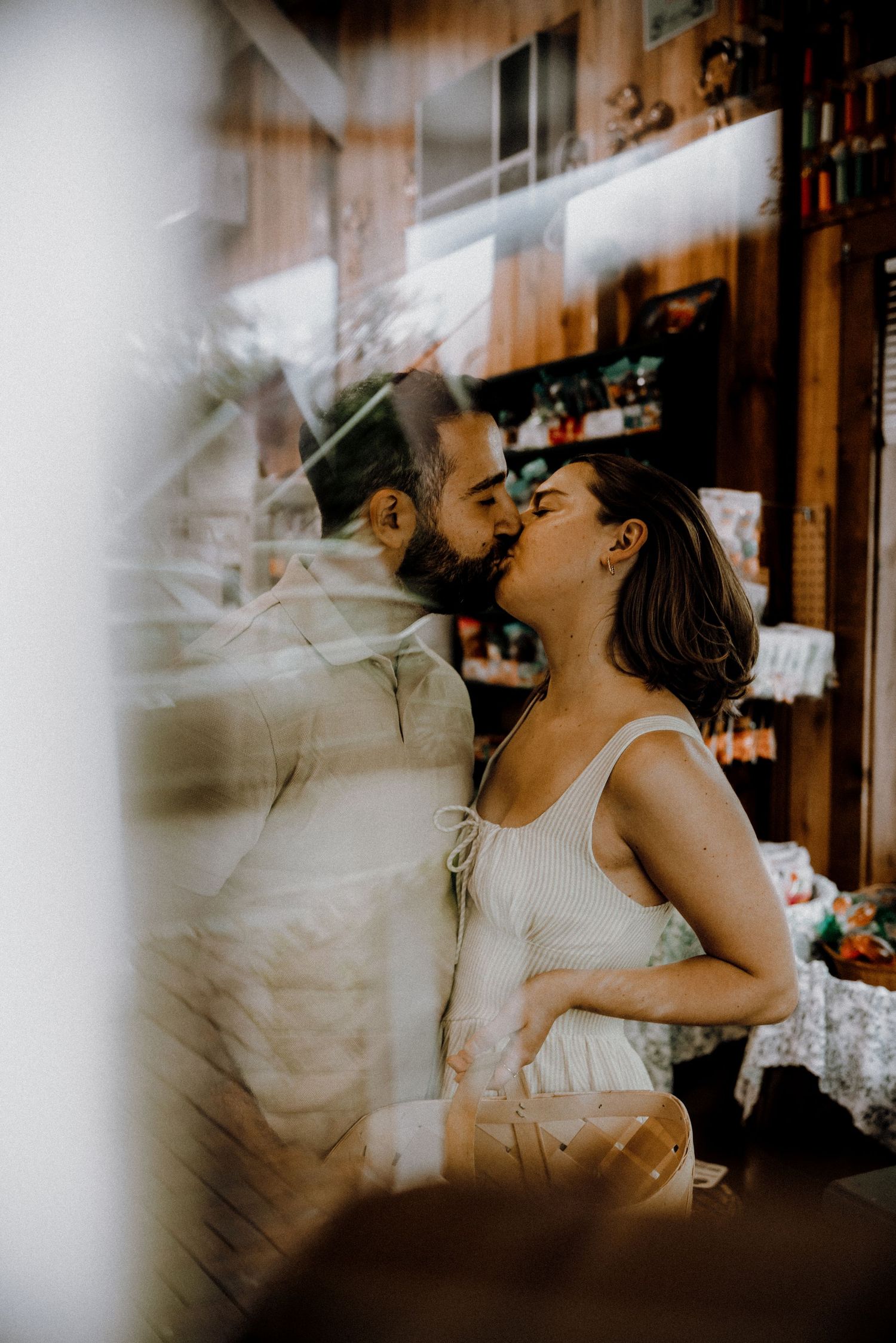 A couple sharing an intimate dance moment in a dimly lit indoor setting.