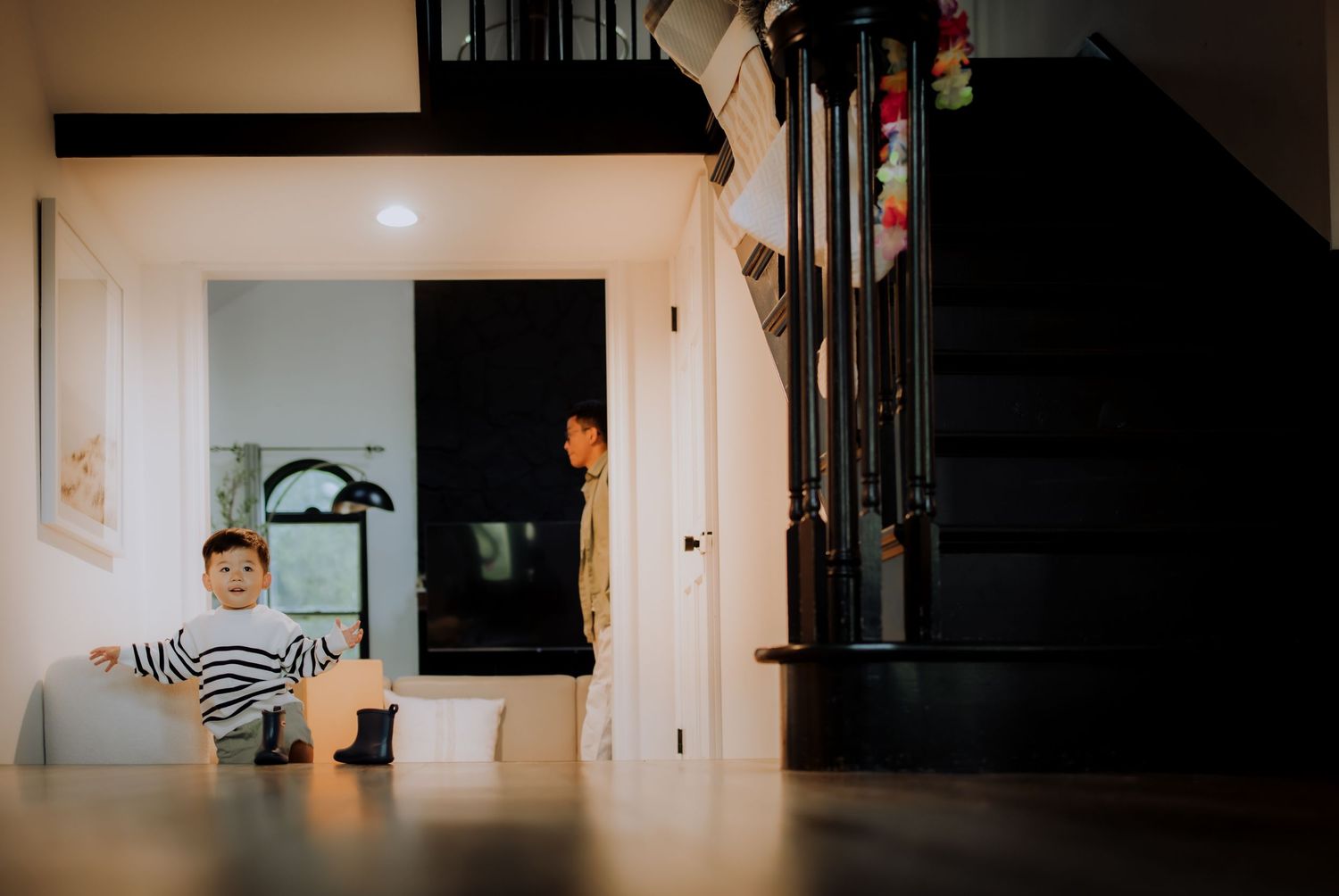 Interior photos showing playful moments with dogs in a minimalist home setting.