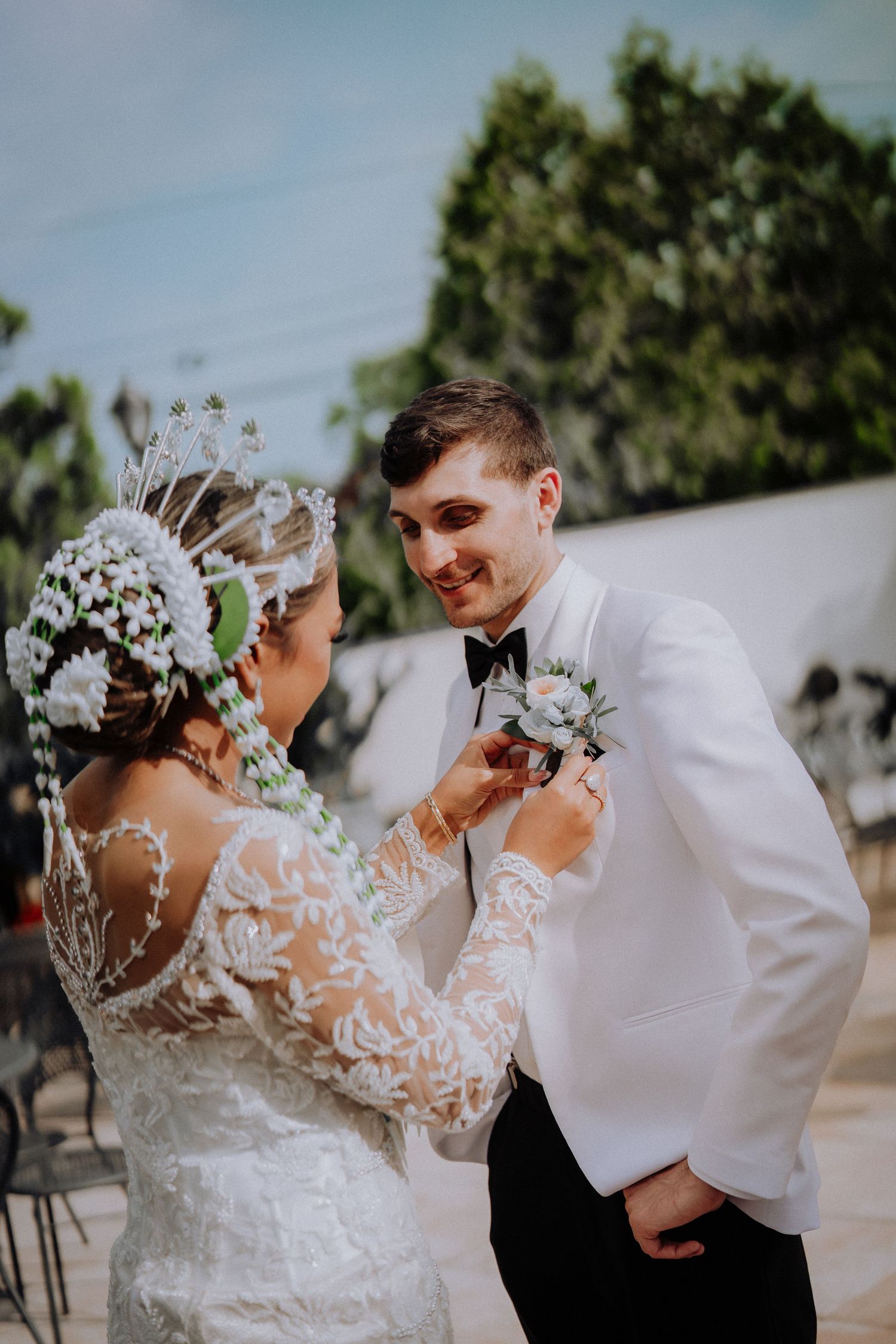A romantic wedding photo sequence showing a couple embracing and dancing together outdoors in formal attire.