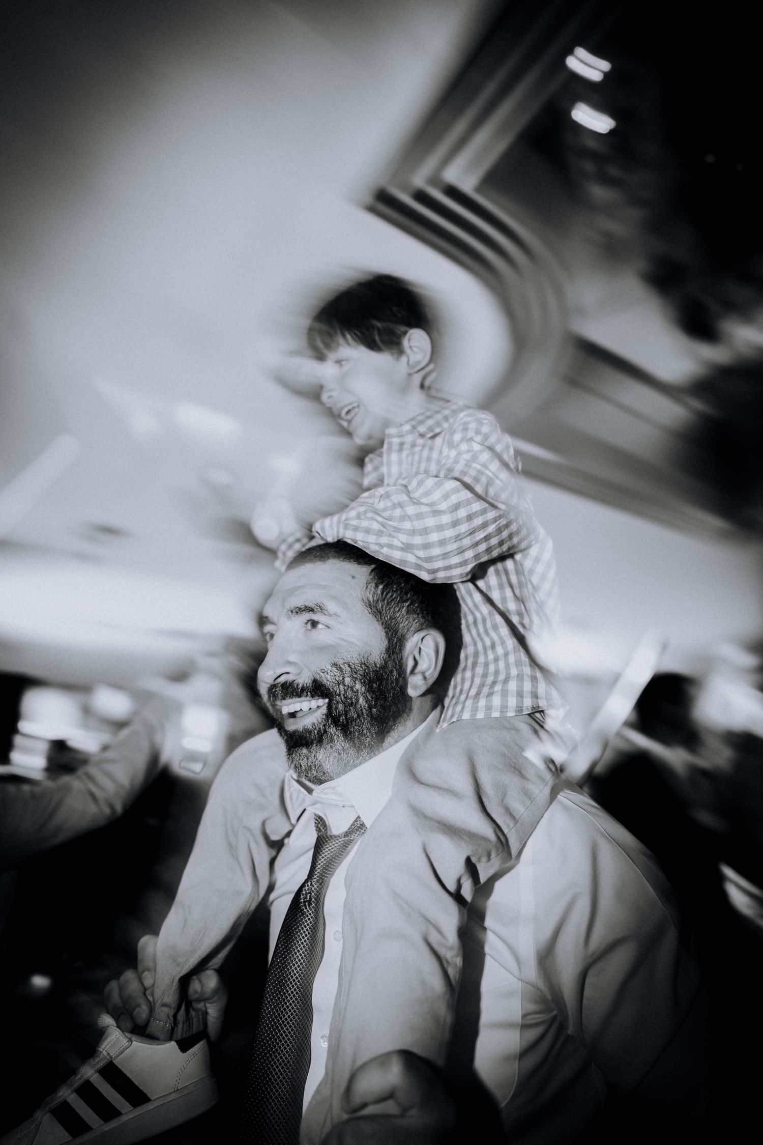 Multiple black and white blurred motion photos showing animated expressions and festive energy in a dimly lit setting.