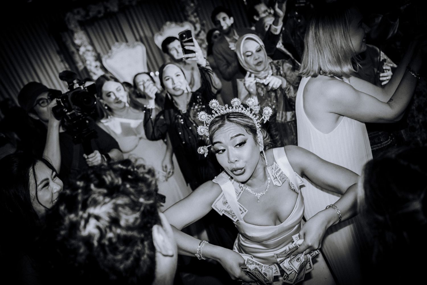 A black and white photo of a crowded dance club scene showing people dancing and partying in an energetic atmosphere.