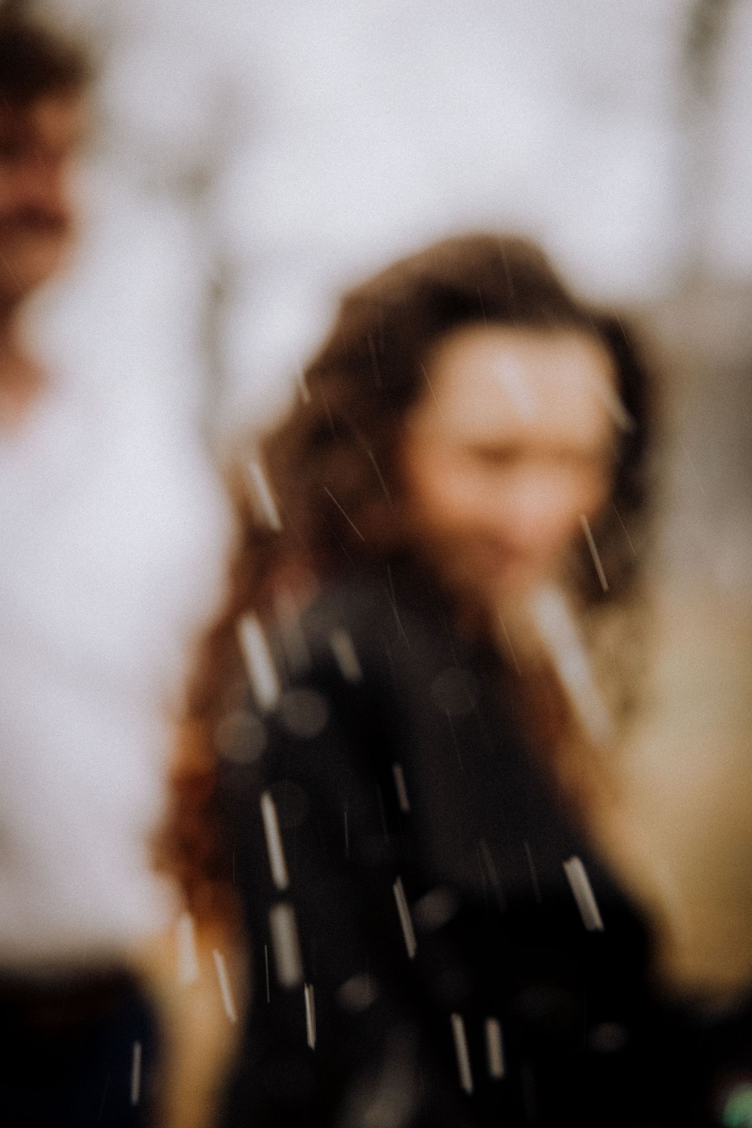 Artistic motion blur portrait with falling snow creates a dreamy atmosphere.