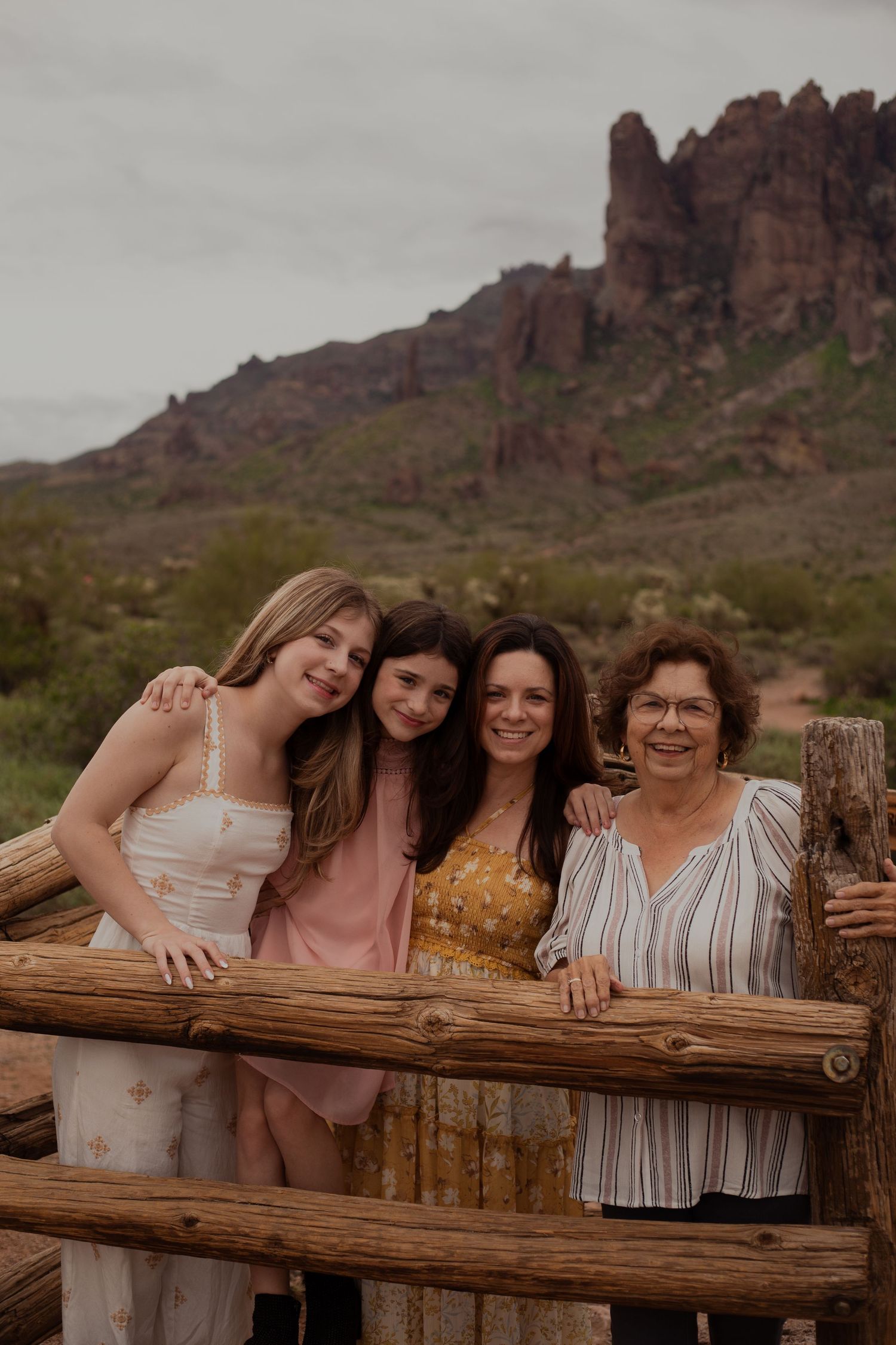 Family of four posing in desert landscape in Phoenix AZ