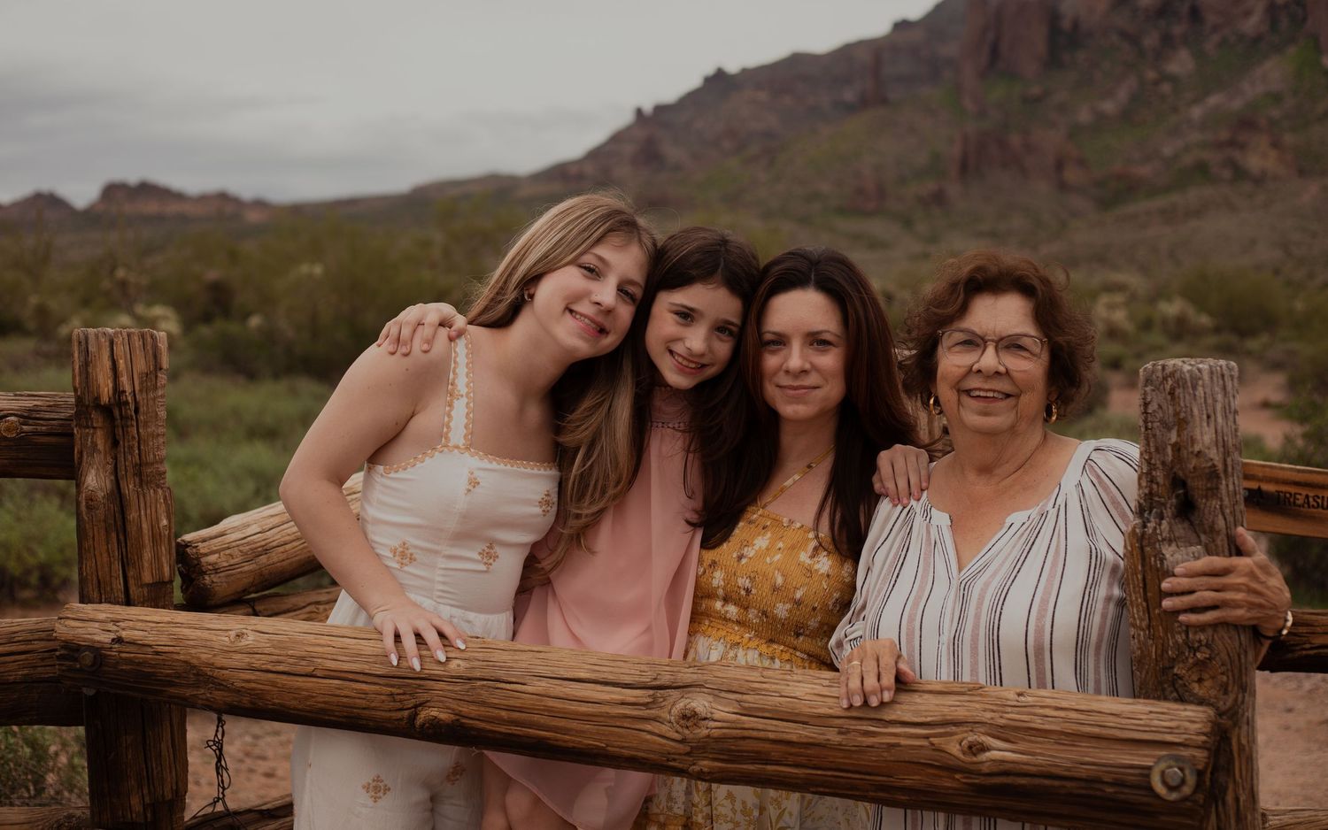 Family of four posing in desert landscape in Phoenix AZ