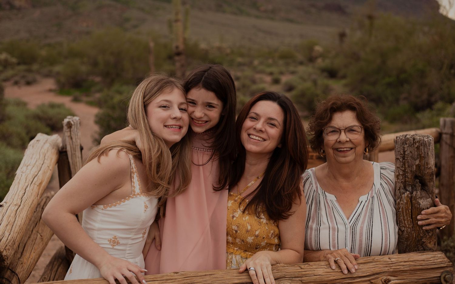 Family of four posing in desert landscape in Phoenix AZ