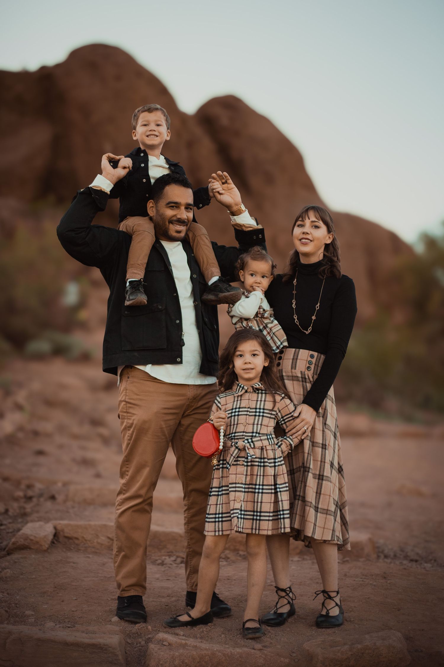 Family of five posing in desert landscape in Phoenix AZ