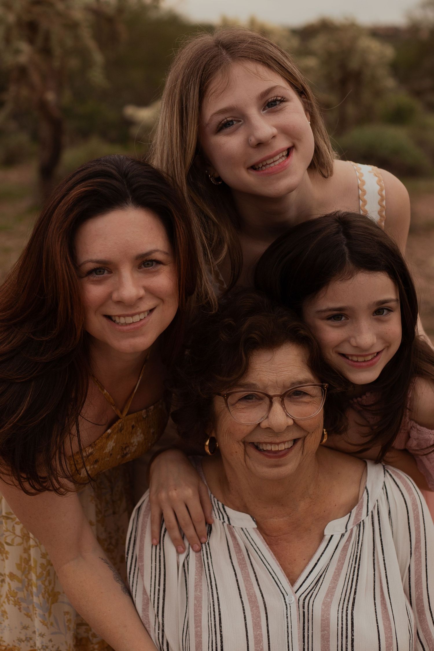 Family of four posing in desert landscape in Phoenix AZ