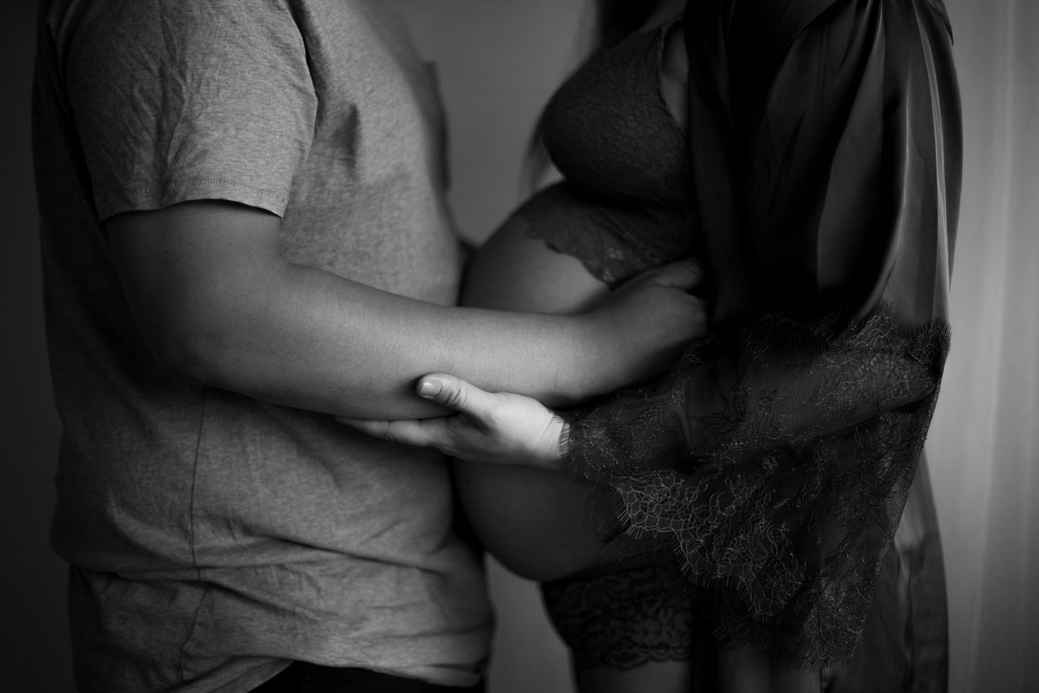 Black and white image sequence showing hands holding and breaking a piece of white chalk.