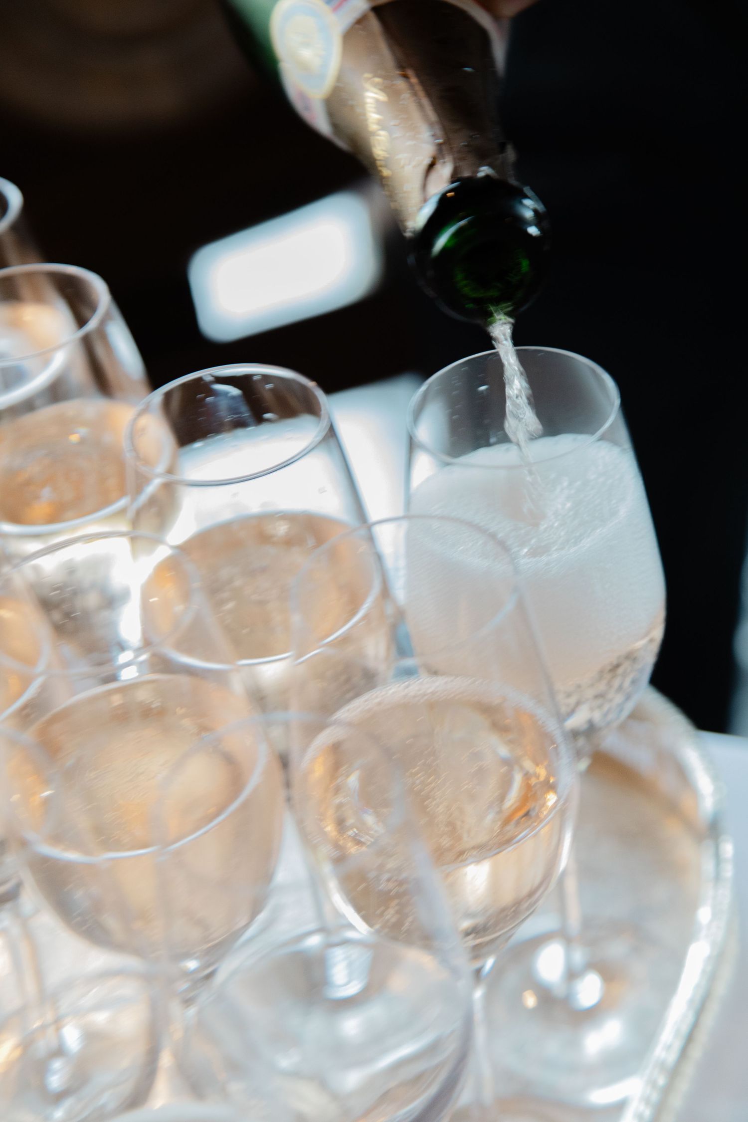 Row of empty champagne glasses lined up at a wedding reception.