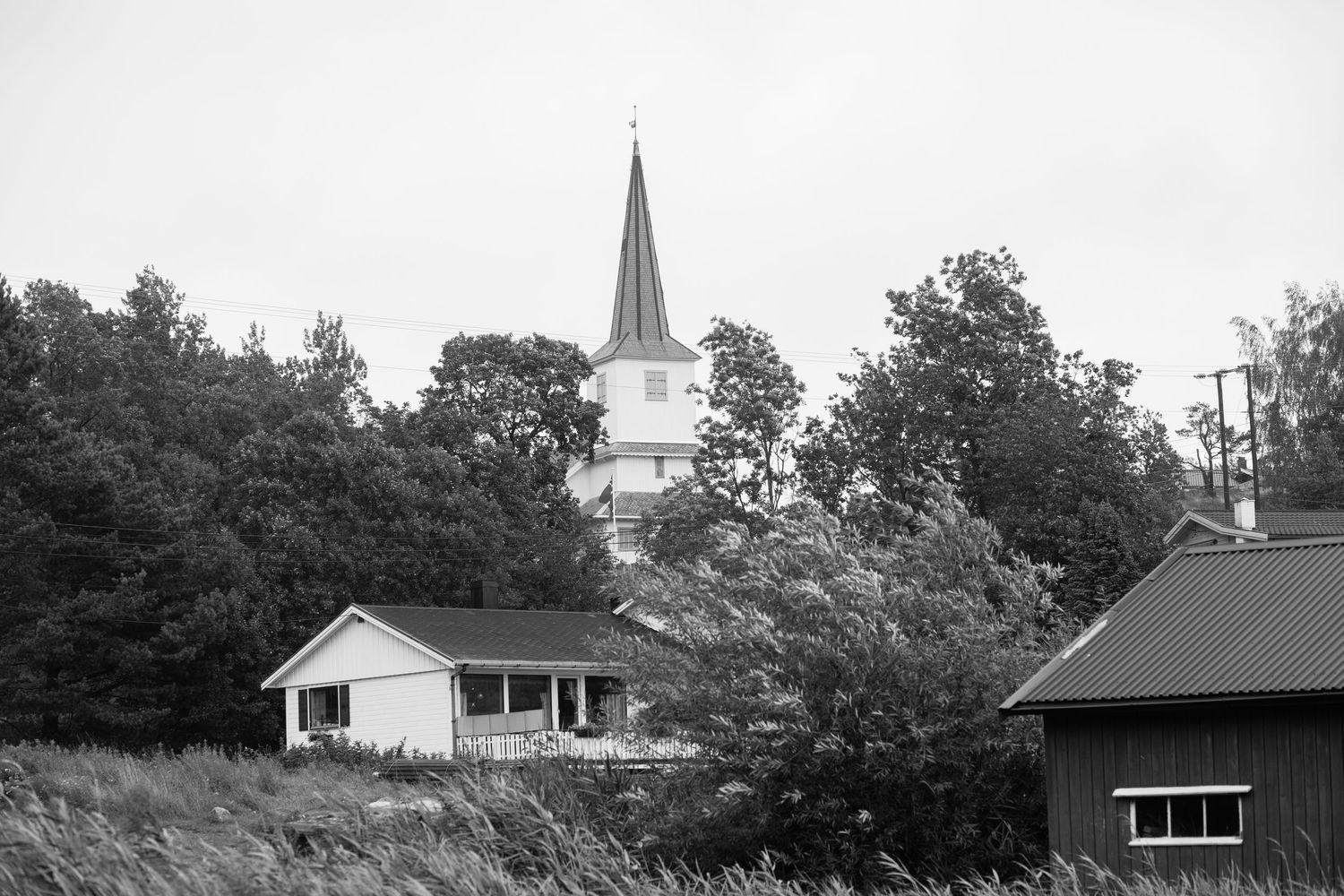Rural landscape with church steeple visible in distance.