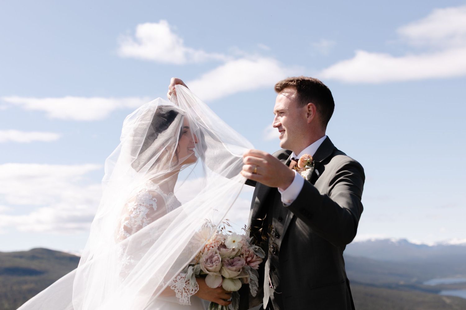 A romantic wedding moment captured against a scenic mountain backdrop.