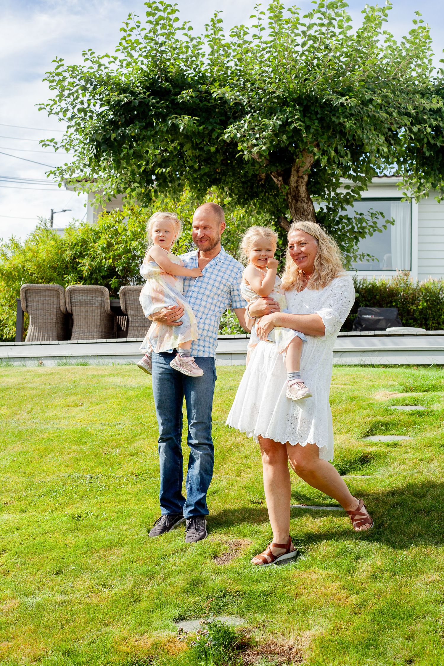 Family enjoying a sunny day together in their backyard garden.