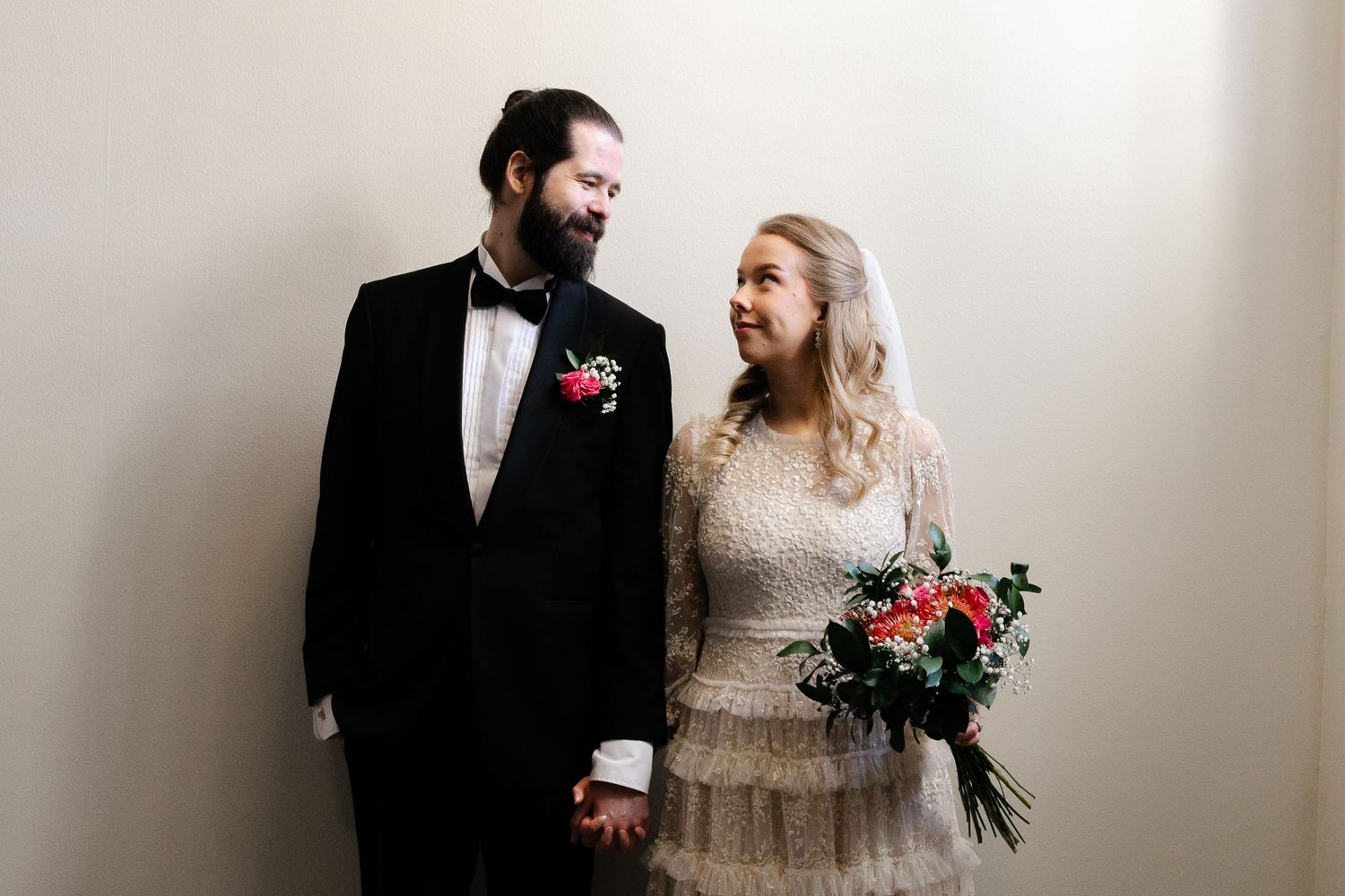 Artistic wedding portraits showing couple in classic black and white attire.