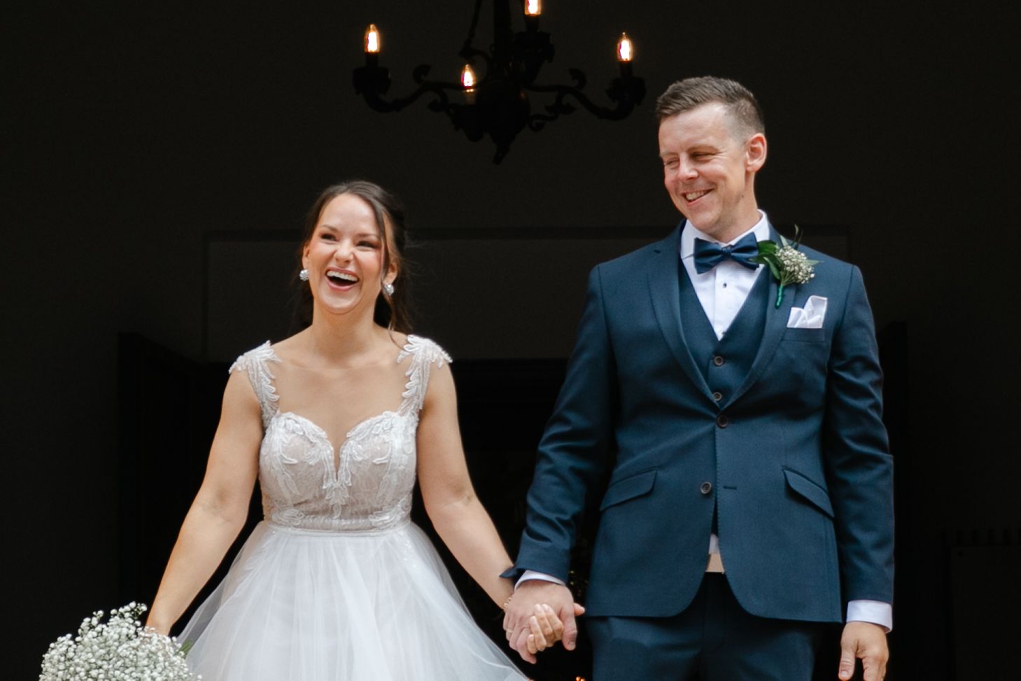 Wedding ceremony in a traditional church with elegant decor and lighting.