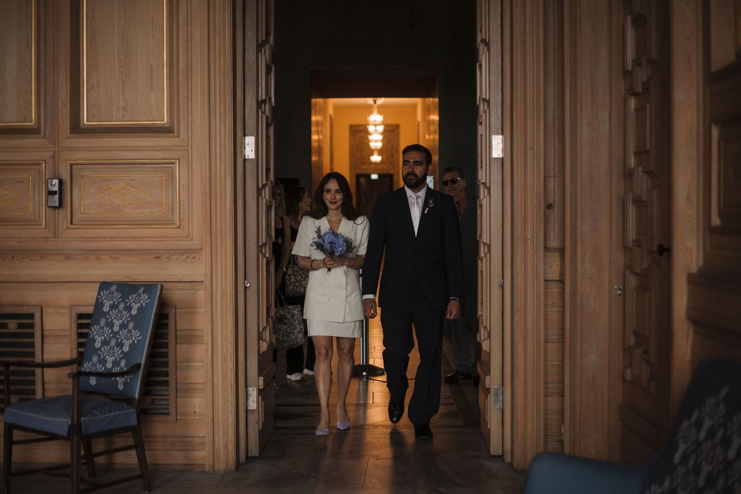 Elegant hallway with wooden paneled walls and warm lighting creates a sophisticated atmosphere.