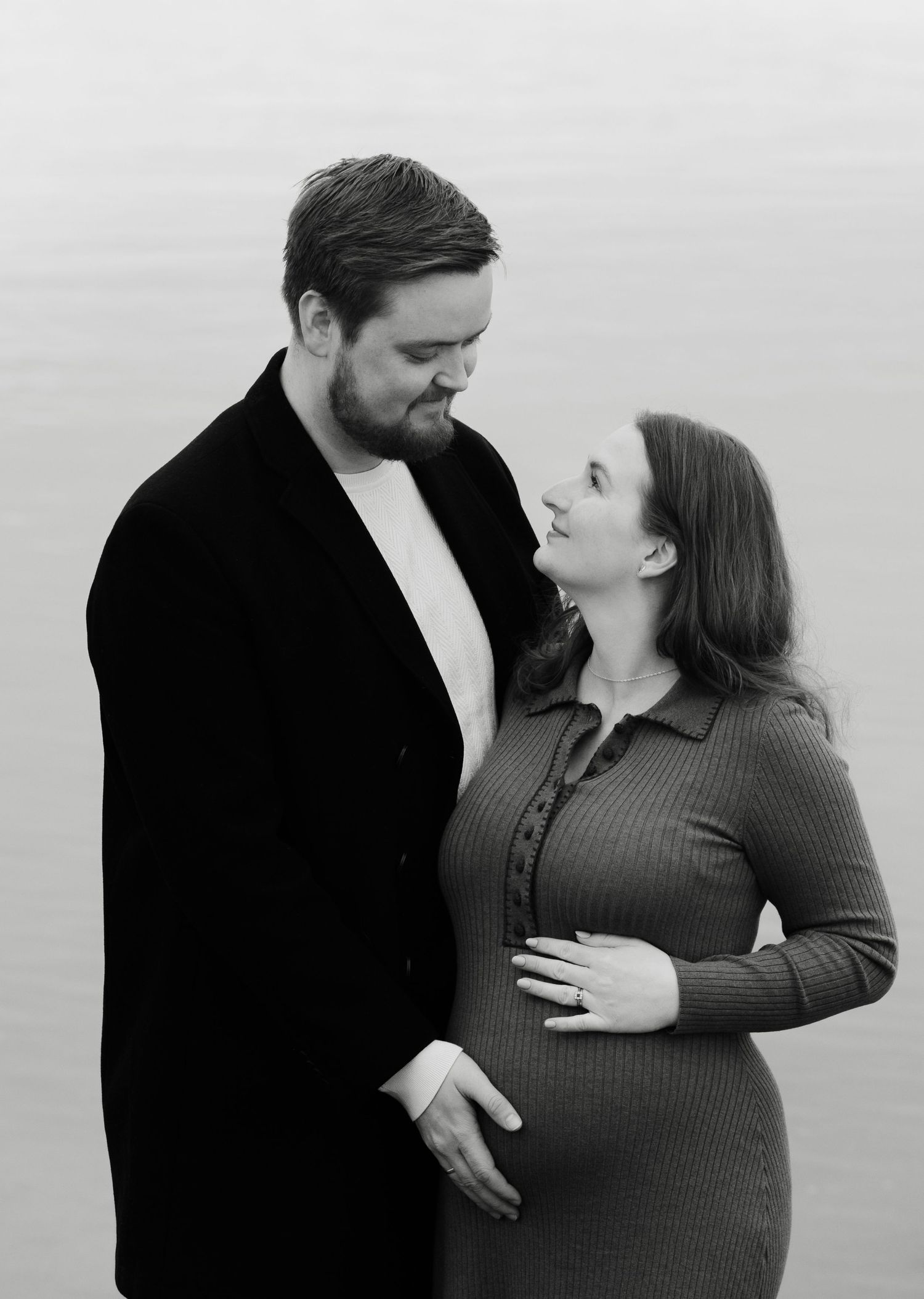 Black and white photo series showing a romantic couple embracing and sharing intimate moments together.