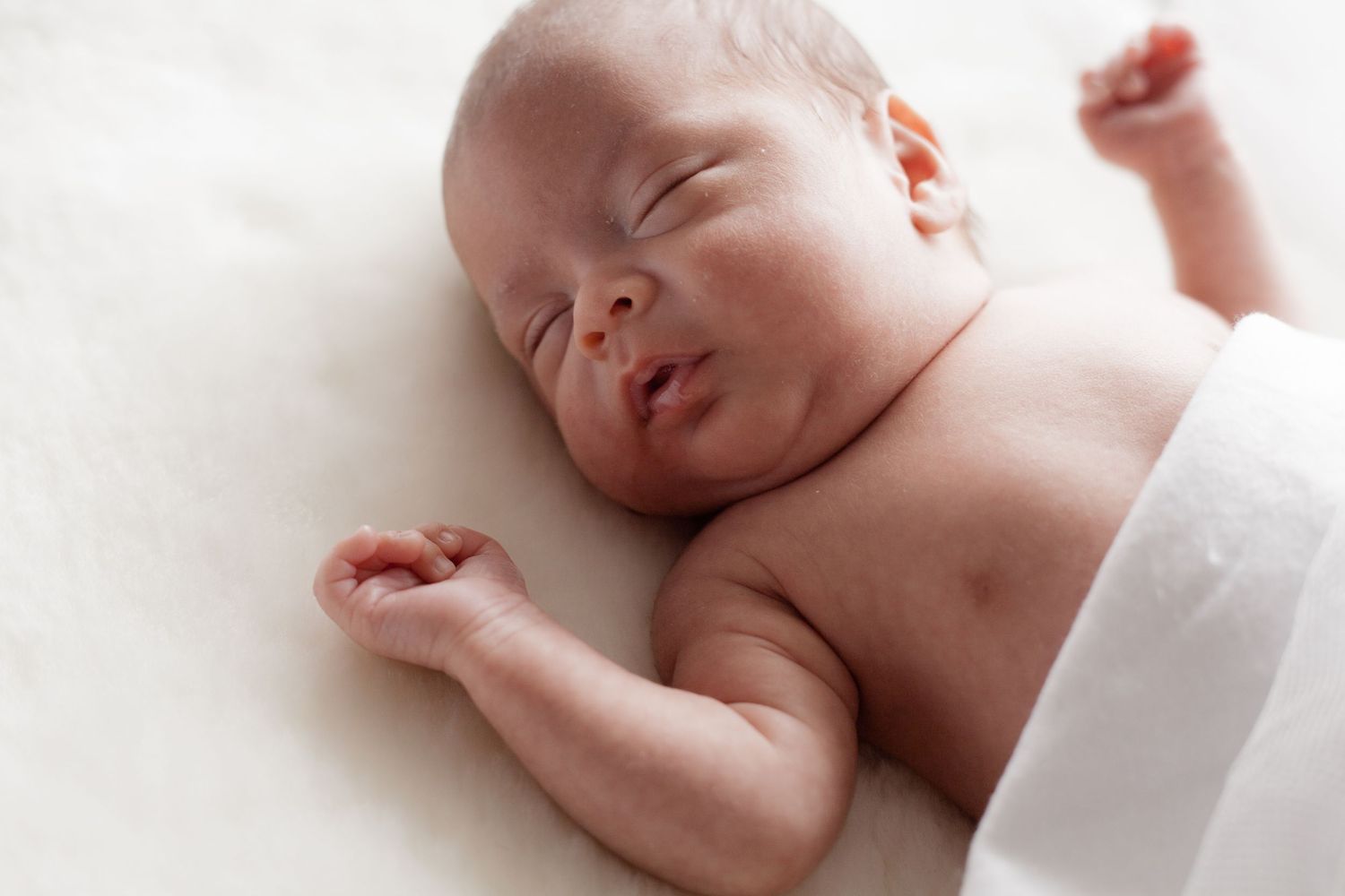 Minimalist newborn photography series highlighting natural sleeping poses.