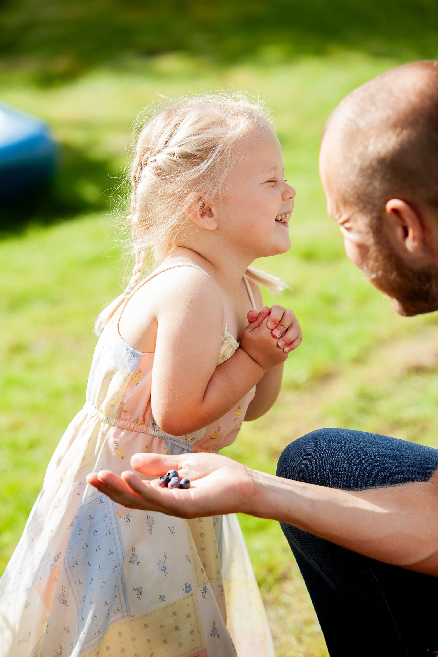 Playful interaction captured in a sunny garden setting.