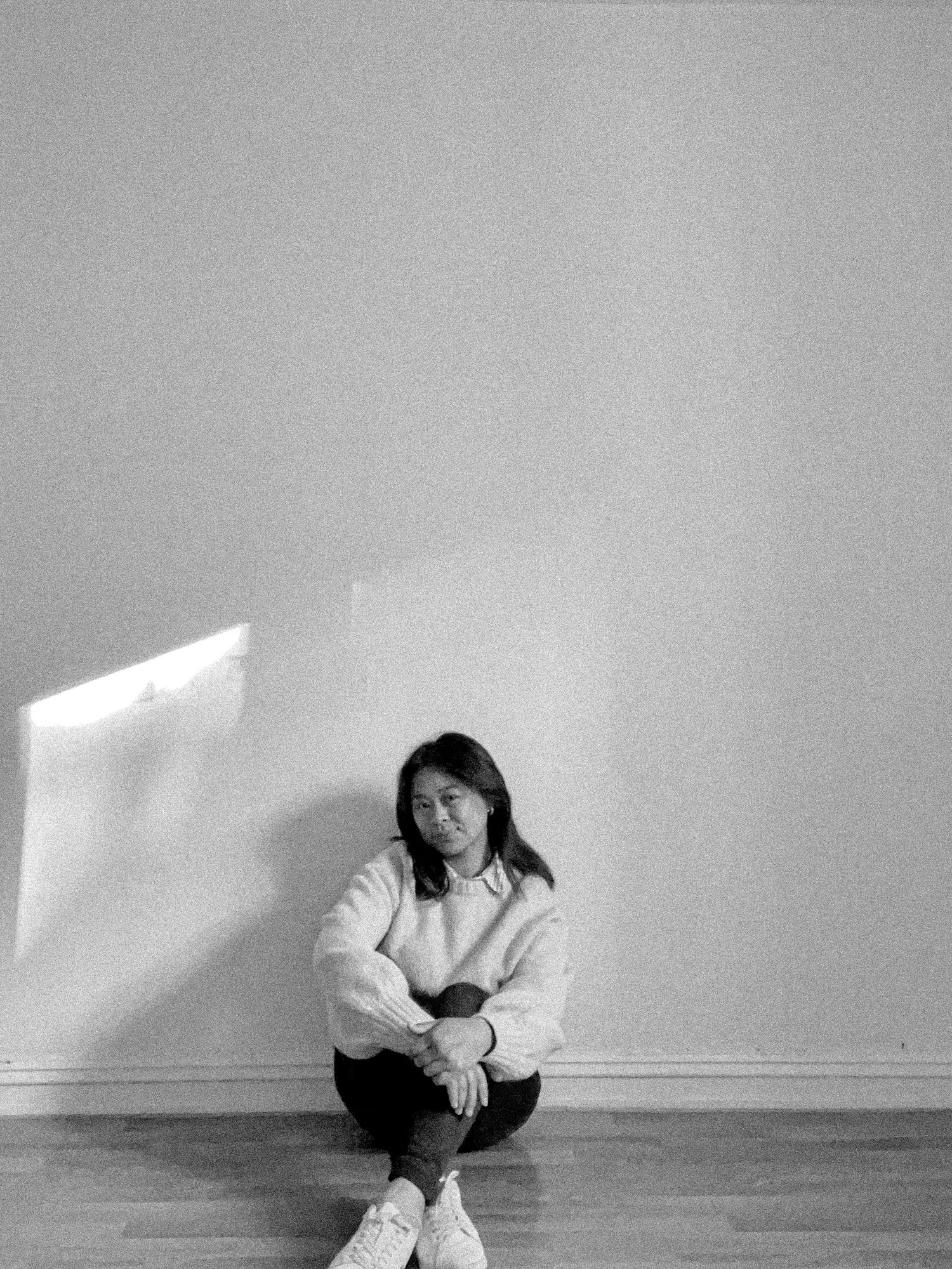 Artistic black and white sequence showing a person in white moving across a minimalist space.