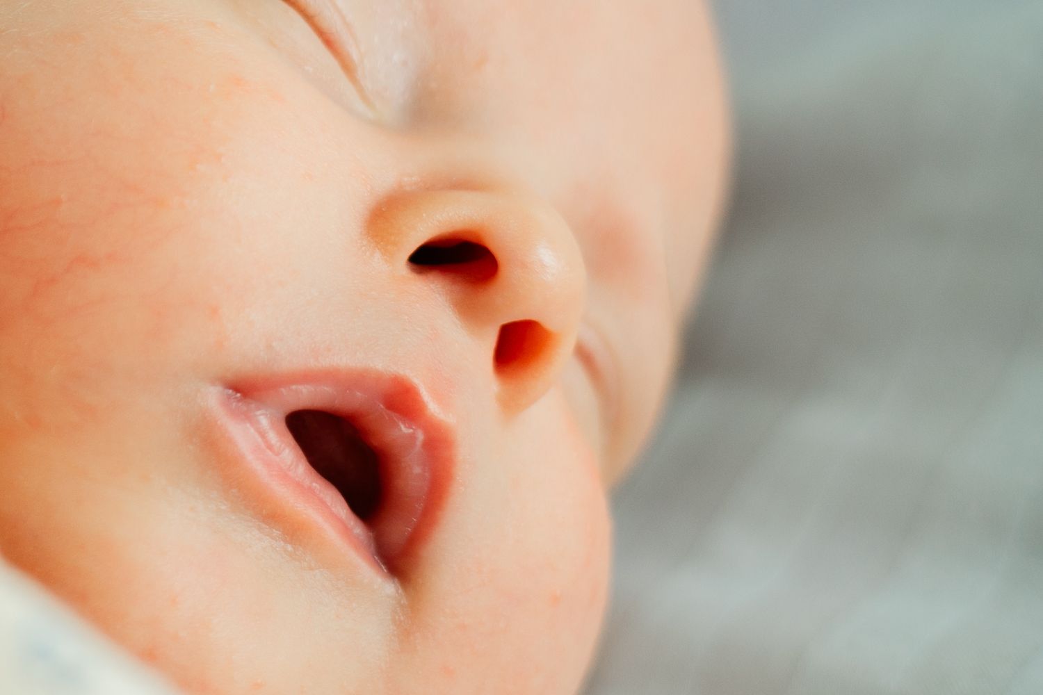 Extreme close-up of a baby's mouth and nose while sleeping.