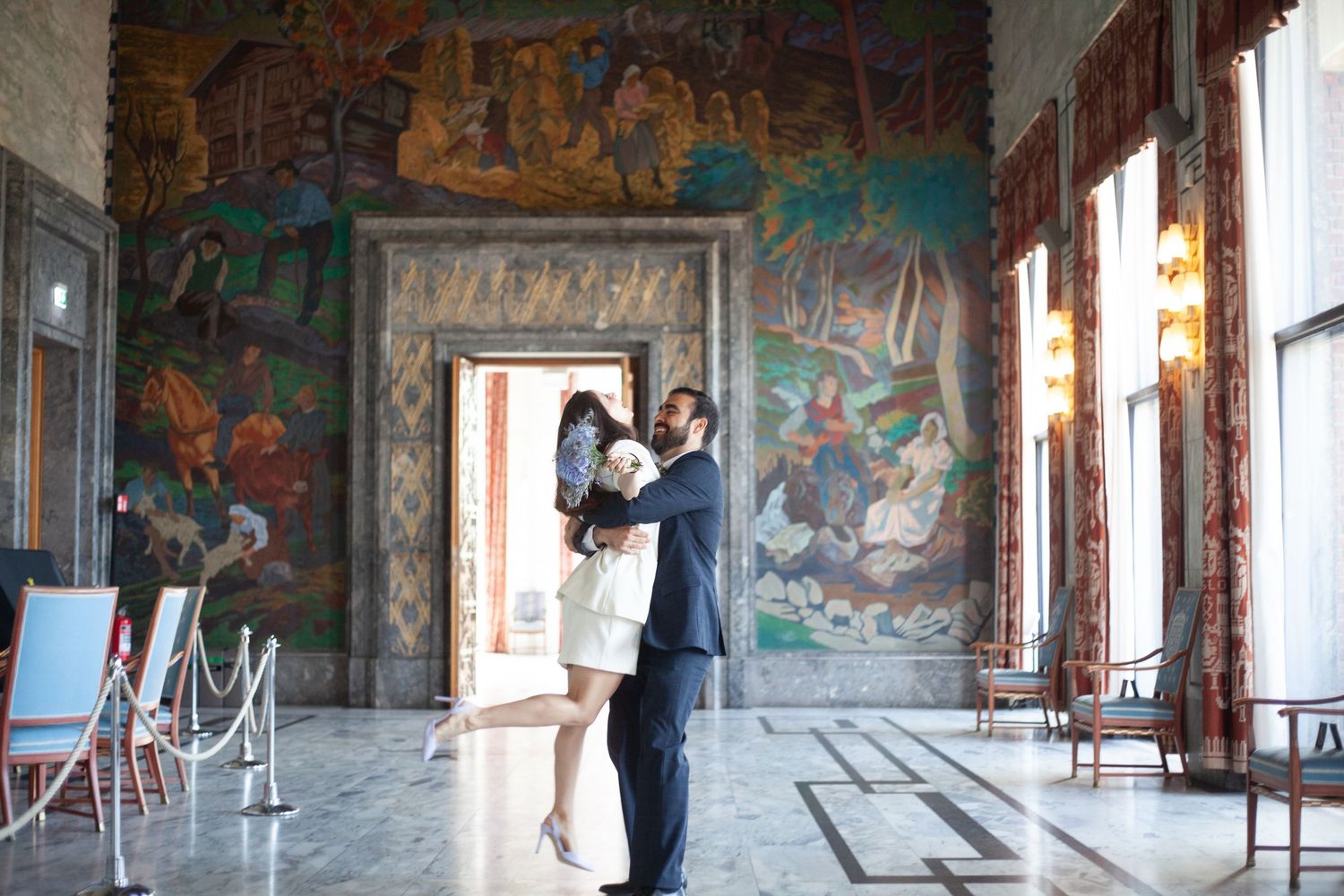 Long hallway with colorful murals and frescoes on the walls and ceiling.