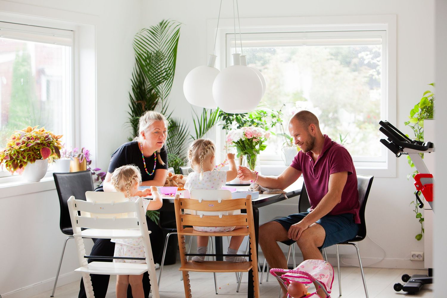 Bright modern dining room with large windows and indoor plants.