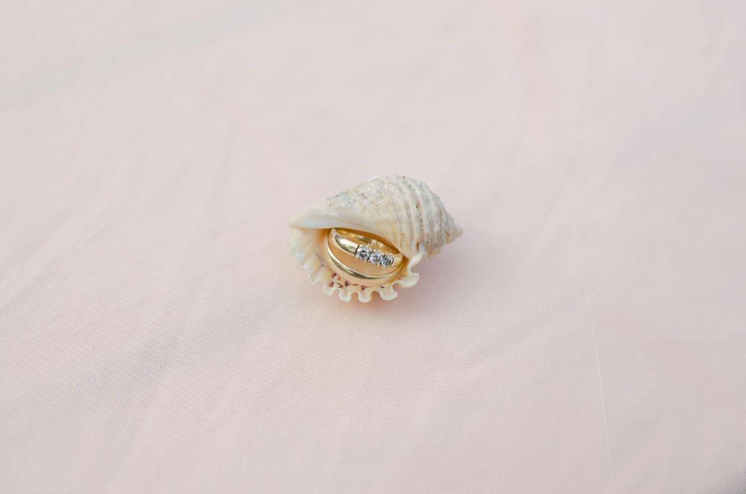 Delicate gold and pearl bridal hair accessories on white background.