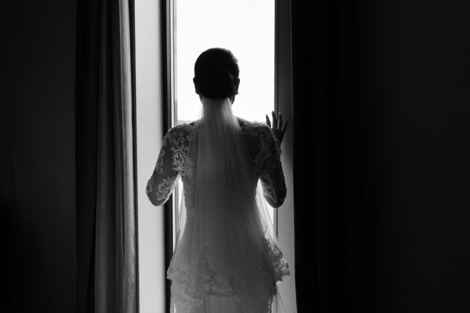 Artistic silhouettes of wedding preparation moments against bright windows.