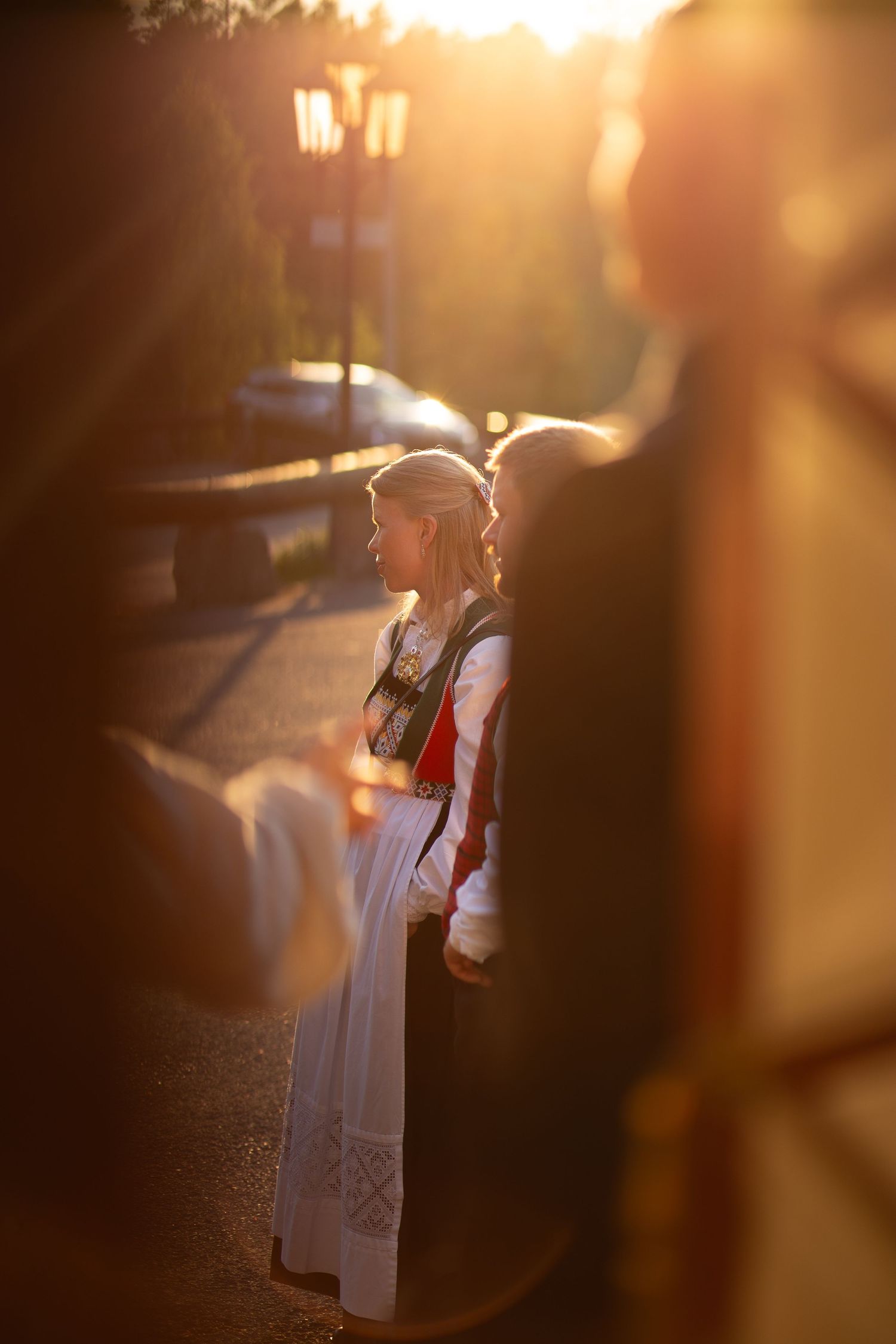 Silhouettes of glass bottles backlit by warm sunset lighting.