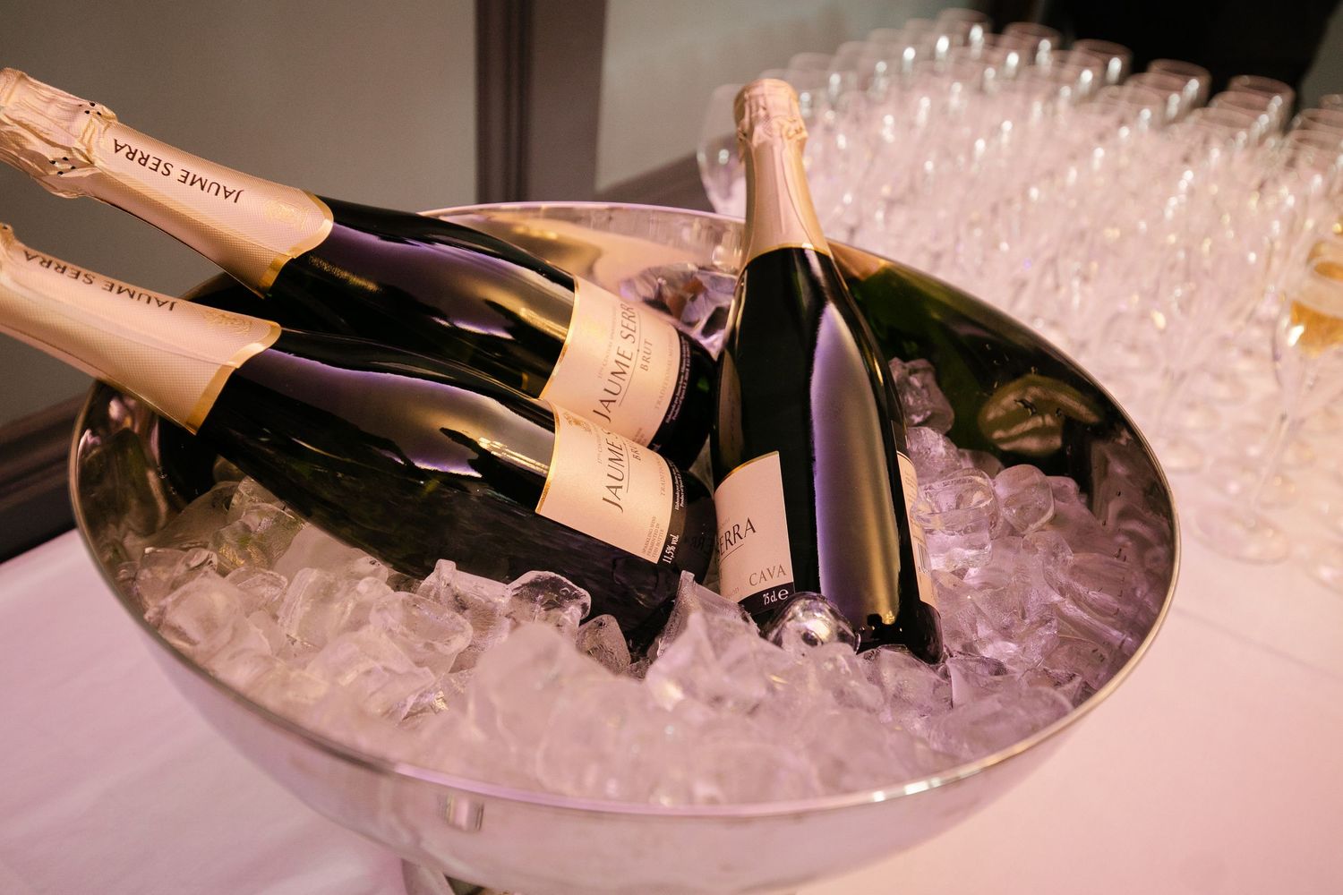 Champagne bottles chilling in ice buckets at an elegant event.