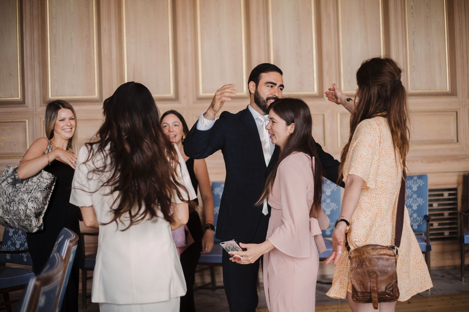 Wedding guests dancing and enjoying themselves at an indoor celebration.