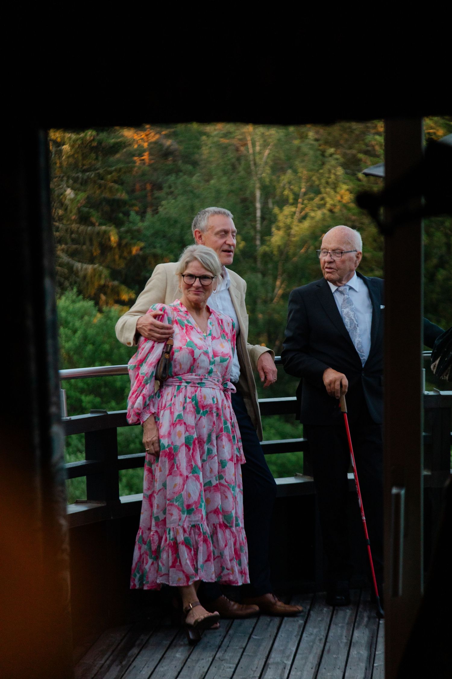 People enjoying a moment together on a wooden deck at sunset.