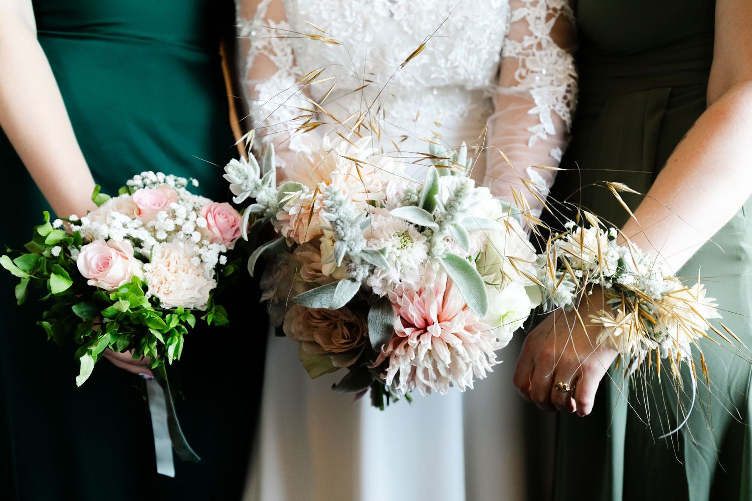 Row of elegant white floral bouquets with lace and ribbon details.