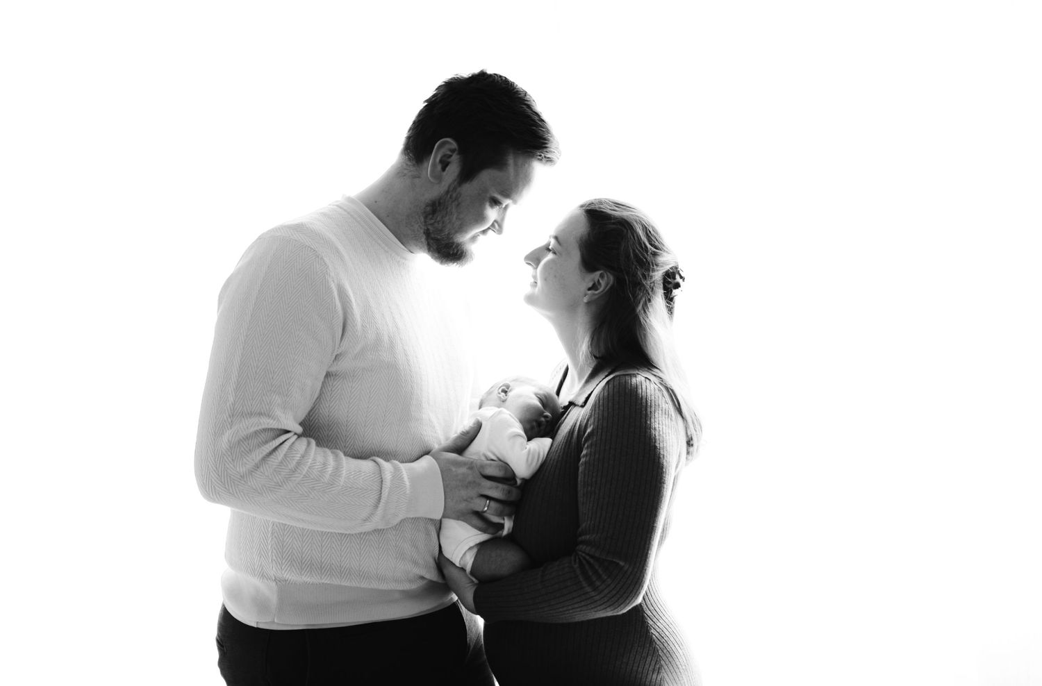Black and white silhouette of couple sharing an intimate moment.