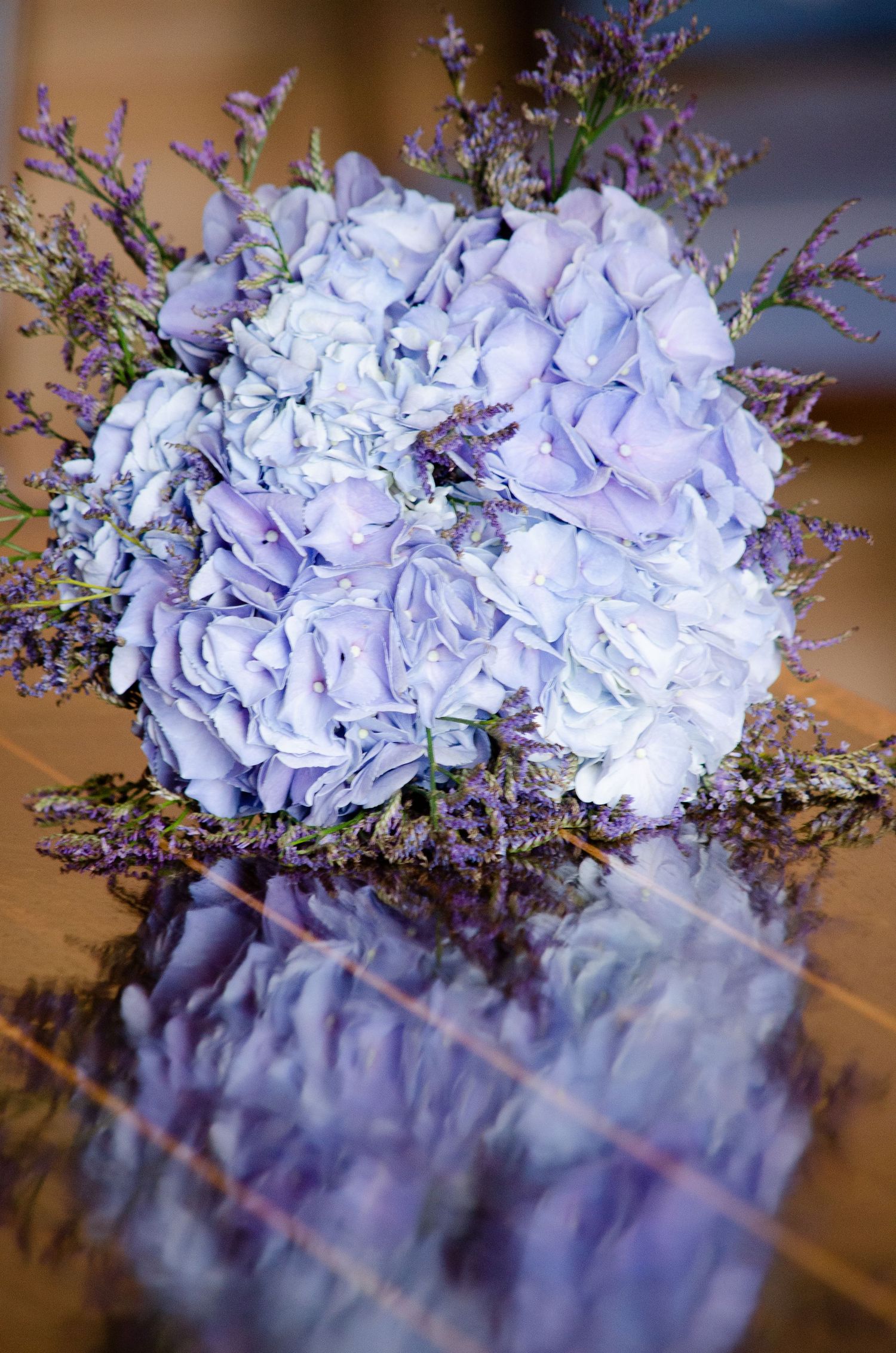 Elegant arrangement of light purple hydrangeas with delicate lavender sprigs.