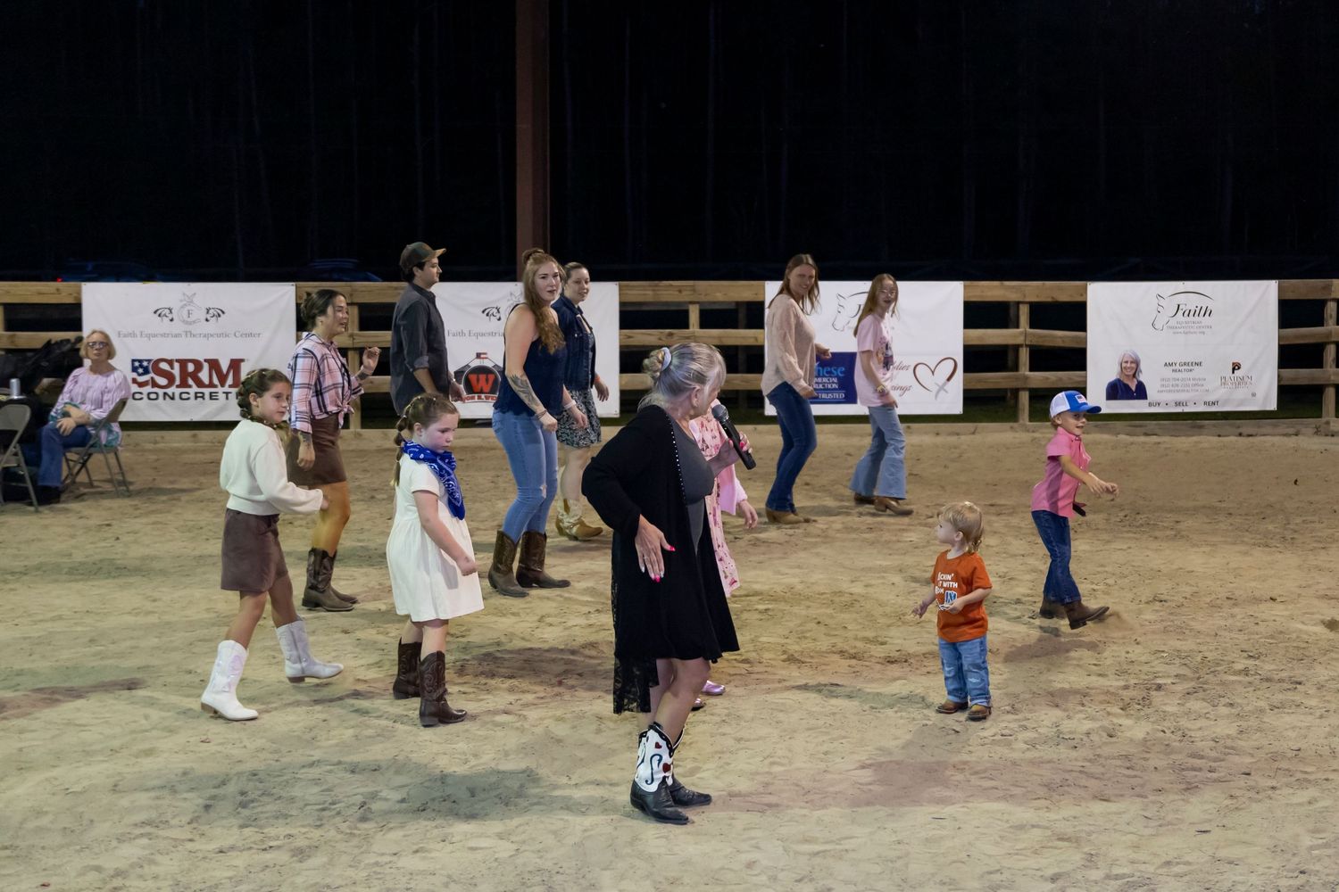 People gathered outdoors on a grassy field for a casual community event.