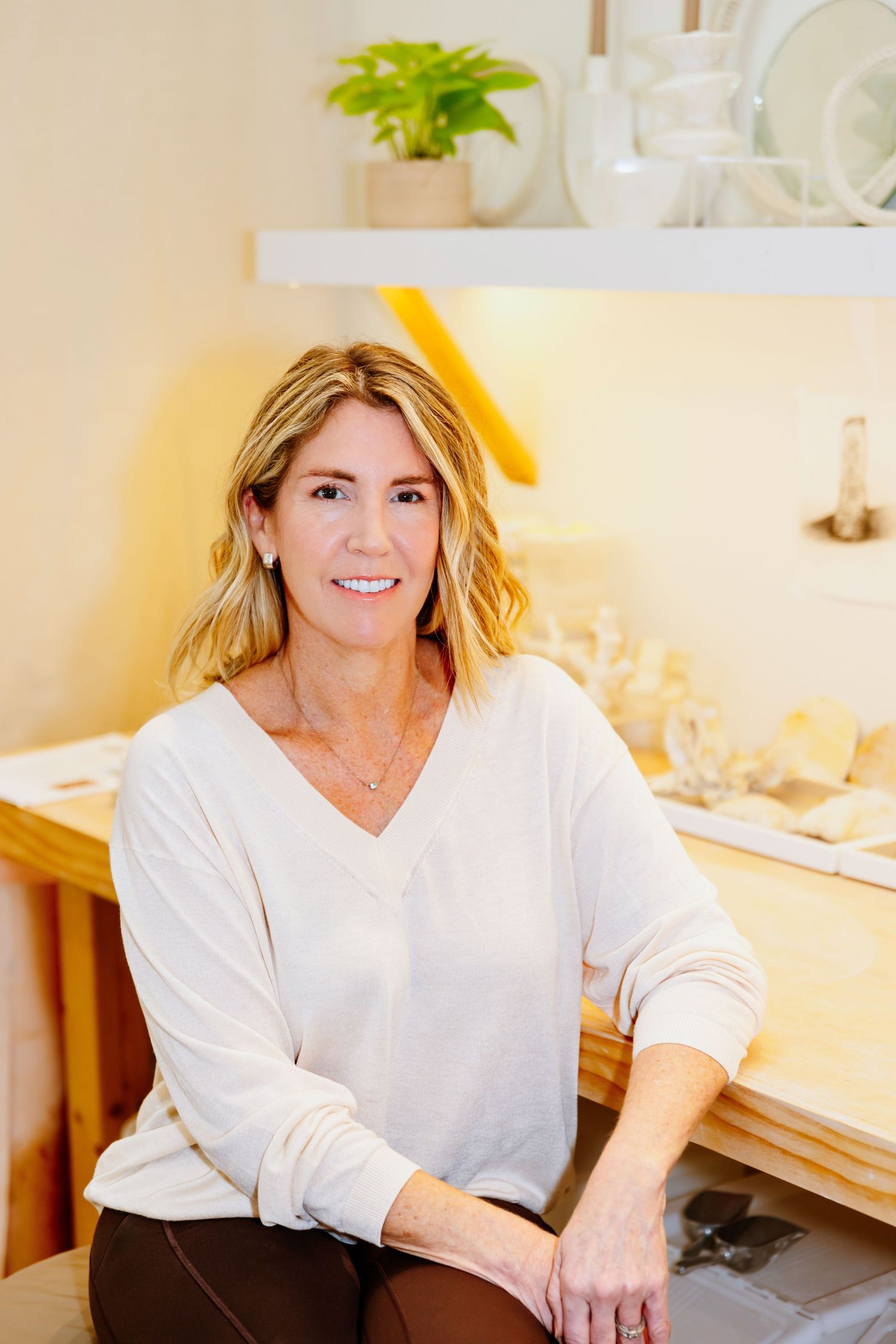 Bright professional headshots in a white office setting with warm lighting and modern decor.