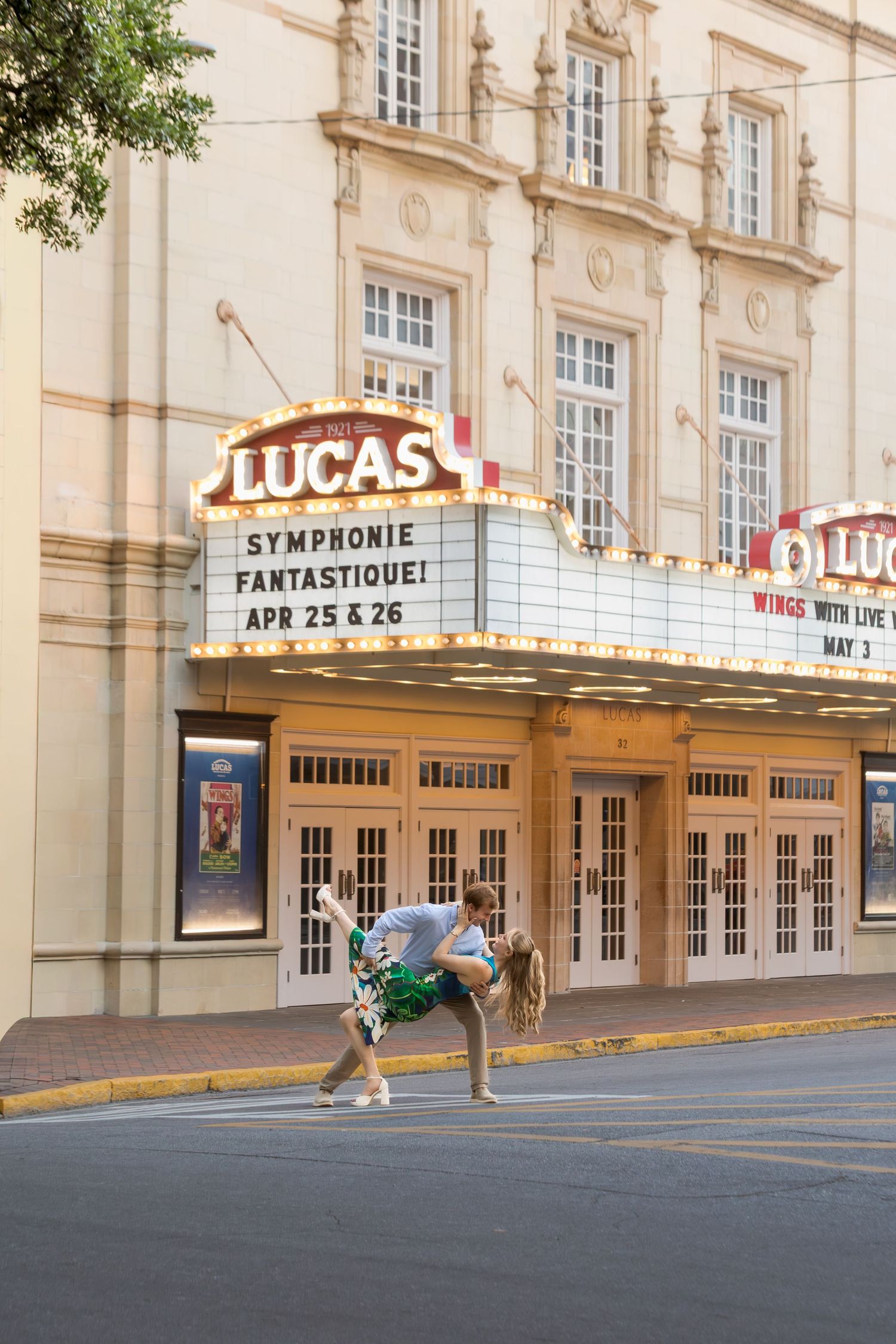 Couple dancing in front of the Lucas Theatre marquee advertising Symphonie Fantastique on Apr 25 & 26.