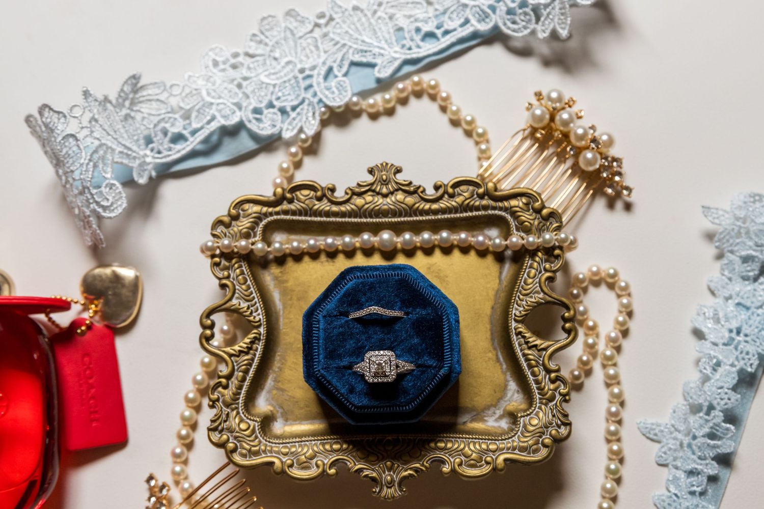 Vintage inspired hair accessories featuring pearl beaded headbands and ornate gold frames with blue velvet details.