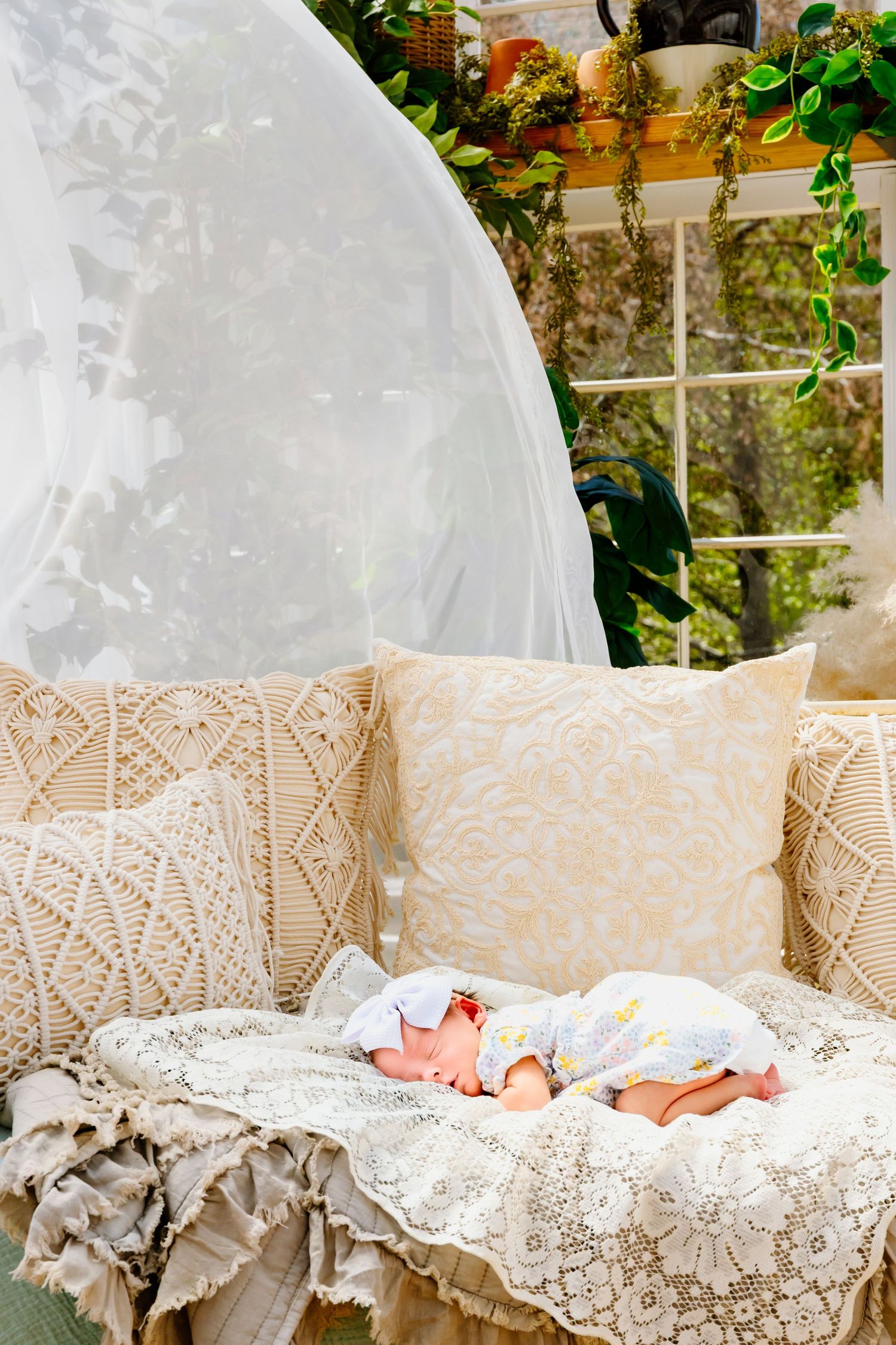 Vintage lace bassinet with delicate pillows in natural light setting.