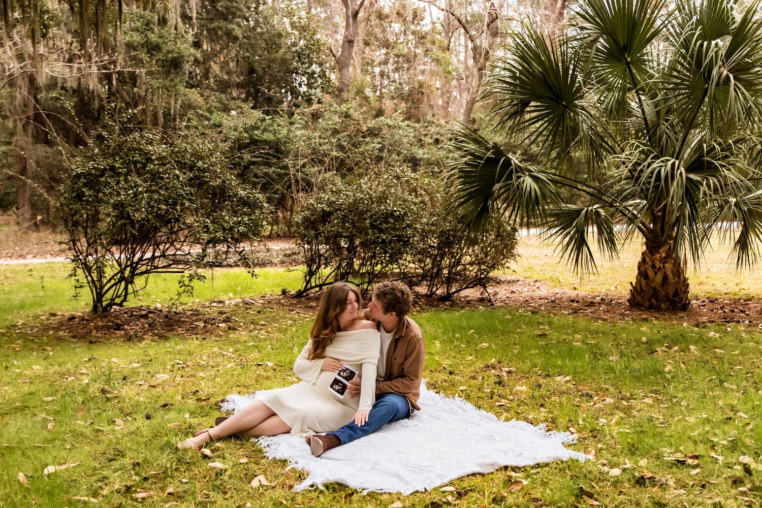 A series of photos showing people enjoying a picnic blanket under palm trees on a sunny day.