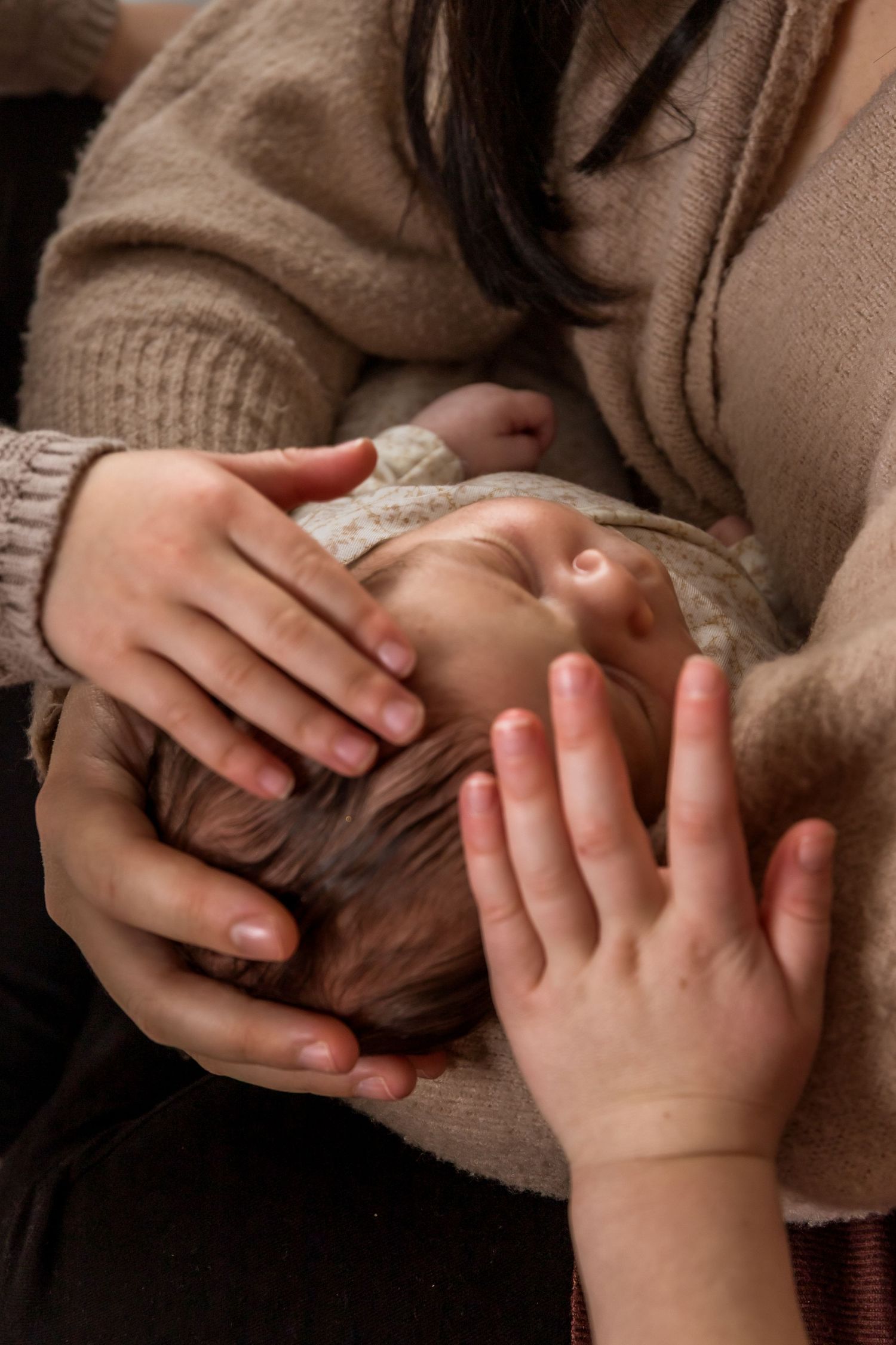 Intimate close-up shots of hands tenderly touching in warm lighting.