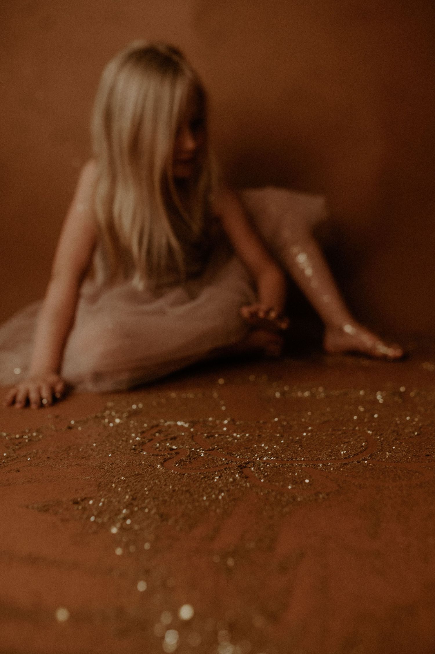 A sepia-toned sequence shows someone picking up small scattered objects from a wooden surface.