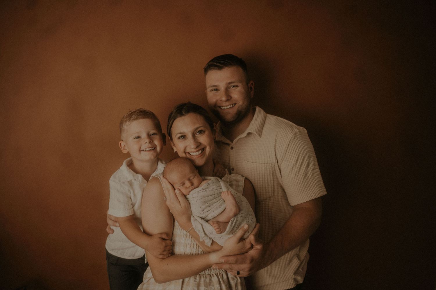 A warm-toned family portrait session in an intimate setting.