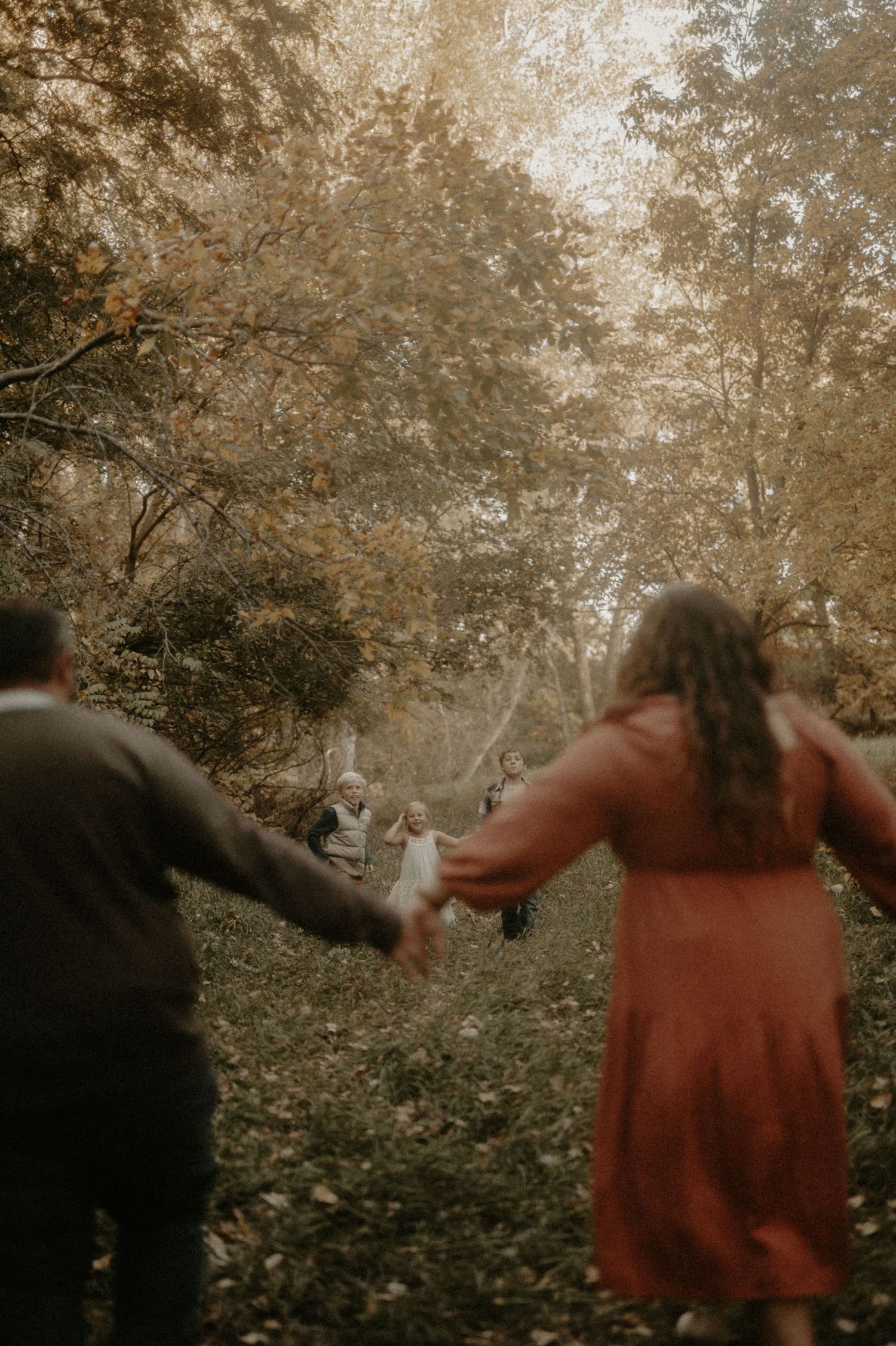 A sequence of motion showing figures in autumn foliage creating a dreamy spinning effect.