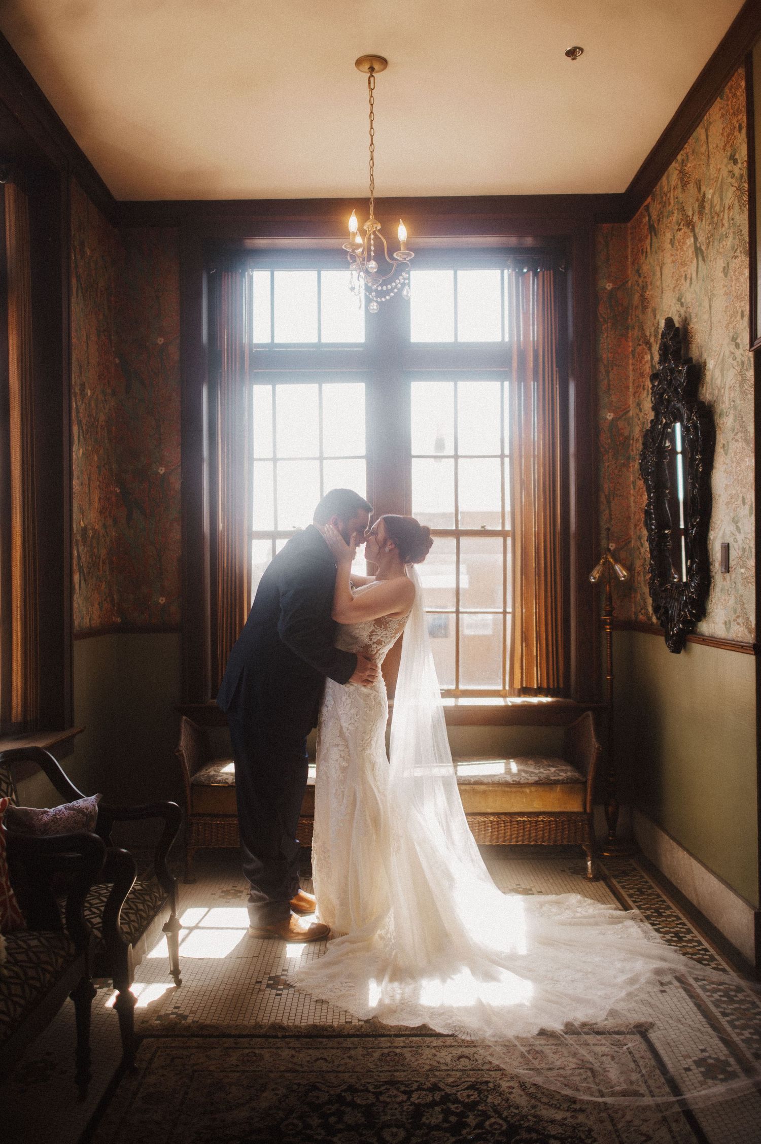 Artistic bridal portraits captured in a historic venue with natural window light.