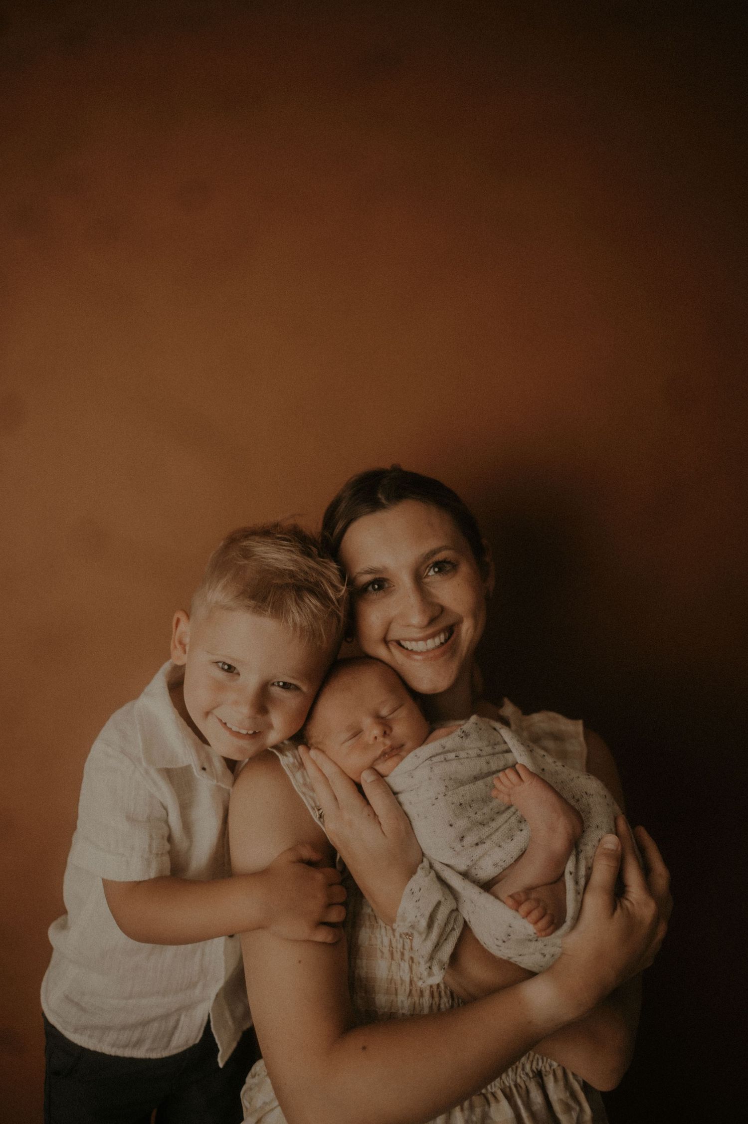 A warm sepia-toned family portrait showing tender moments of affection and connection.