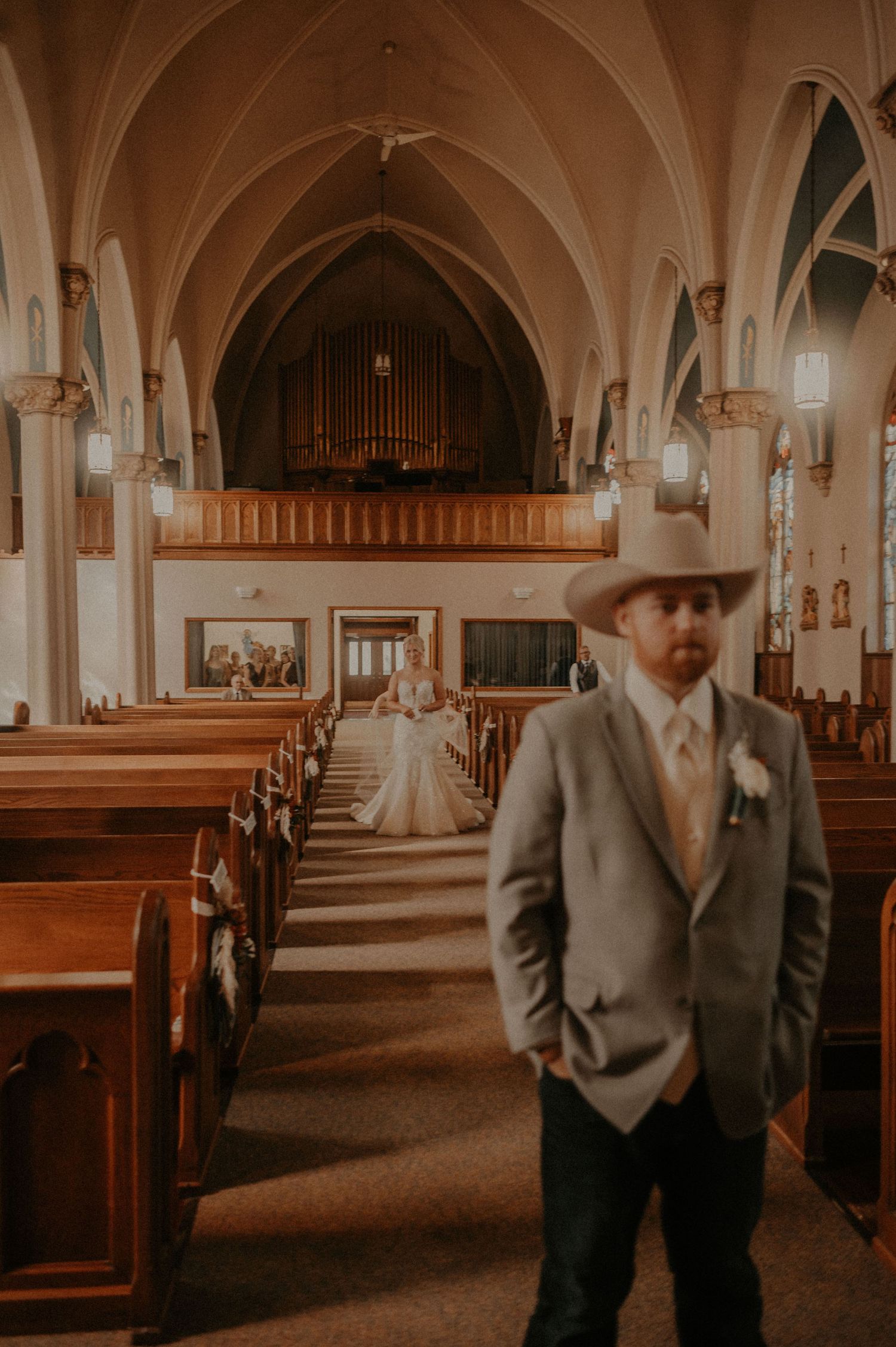 Elegant church sanctuary with vaulted gothic architecture and wooden pews bathed in warm lighting.