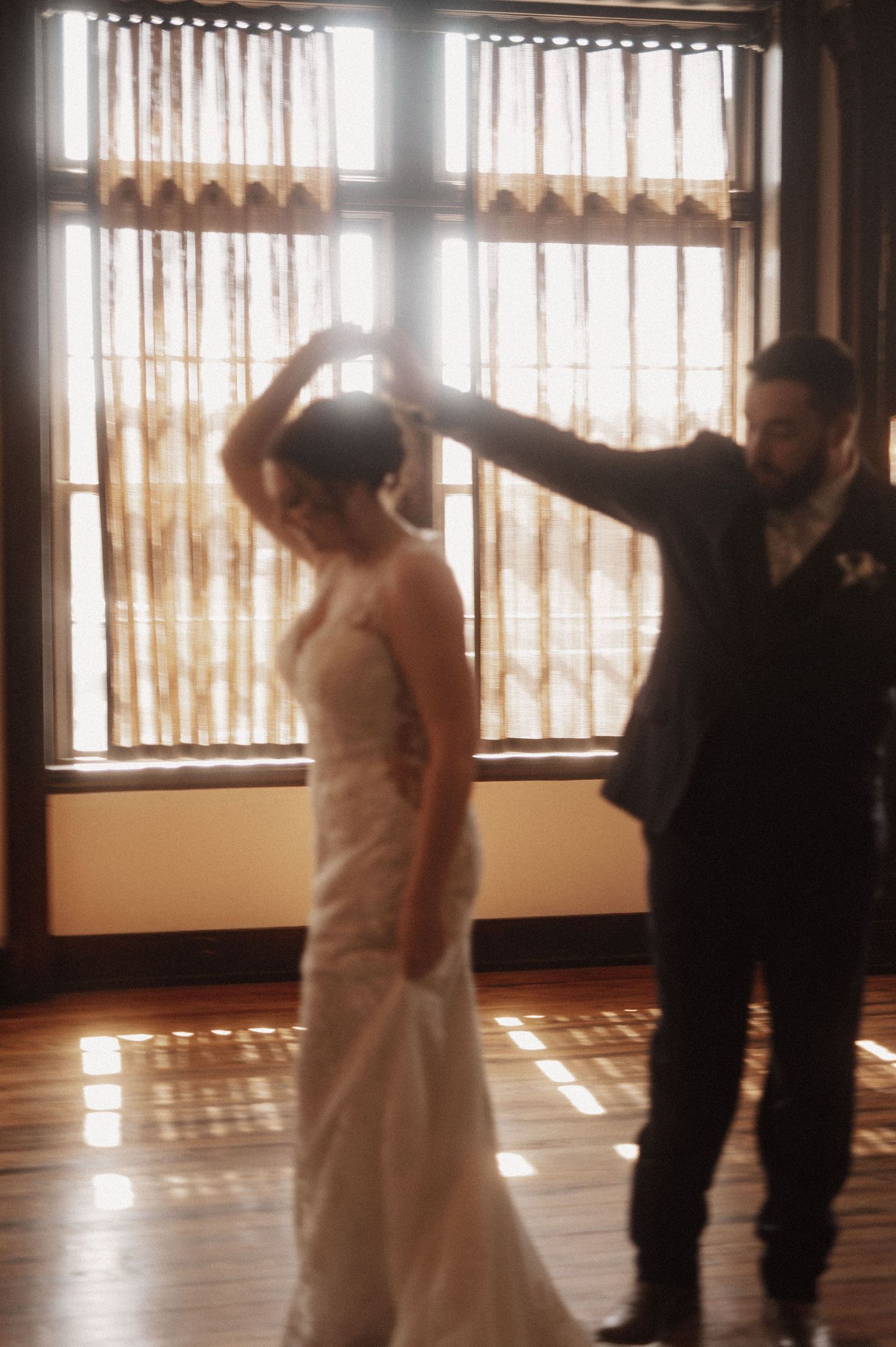 A sequence of dance moves captured in a sunlit room with vertical blinds.