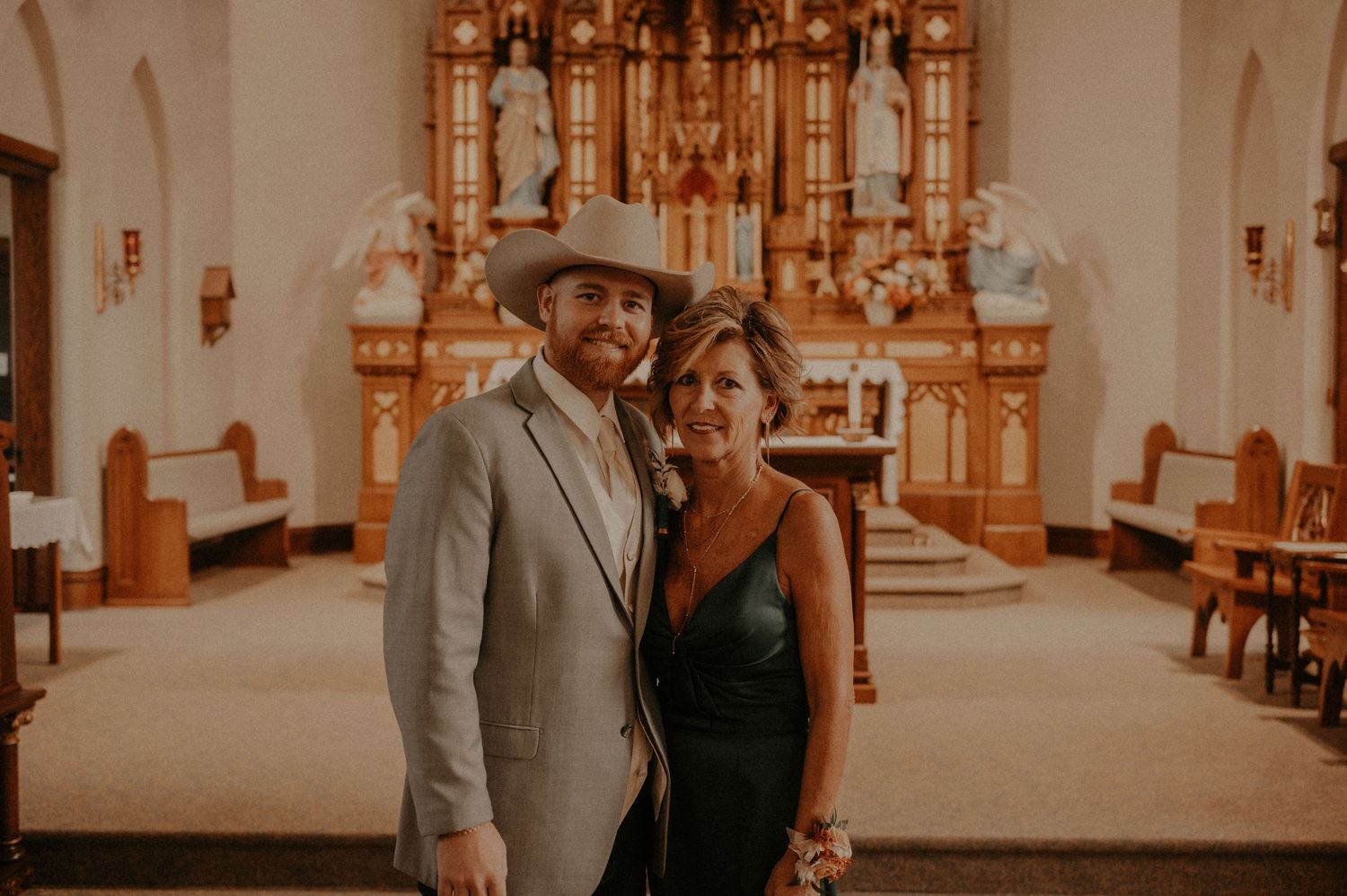 Wedding ceremony photos in a historic church with stunning architectural details and wooden pews.